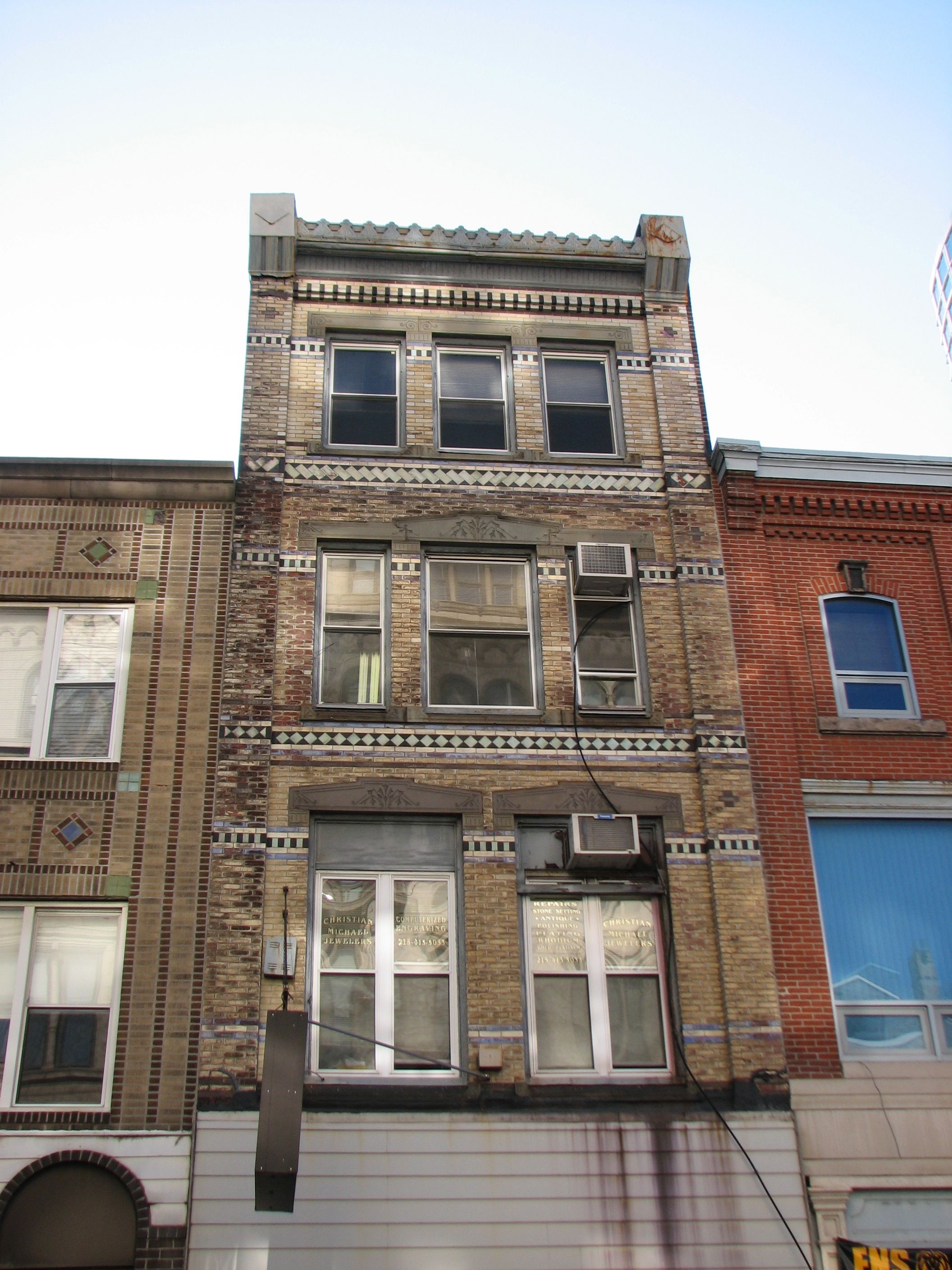 Belts of decorative brick adorn a 19th century buildings on Sansom.