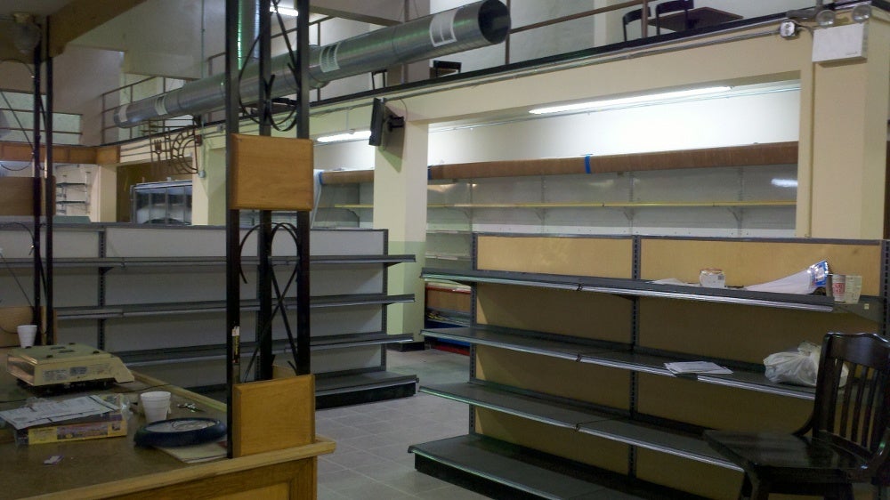 Shelves for dry goods and refridgerated items, with part of the upper-level seating area