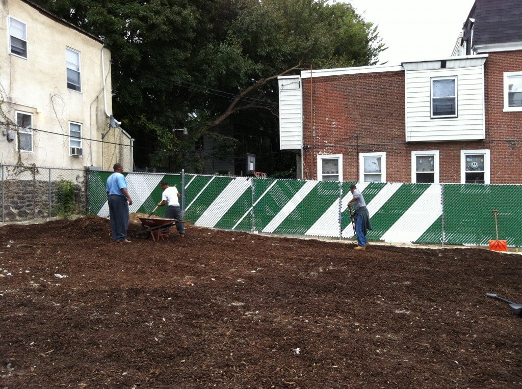 Neighbors clean a Germantown lot. (Photo credit: Aine Doley)