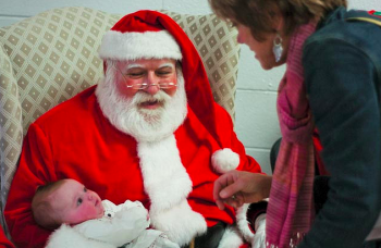 Three month old Feona Conti visits Santa with grandmom Katie Conti  at the Mayfair holiday celebration in 2009. Photo by Bill Achuff.