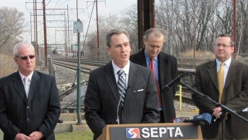 Sen. Mike Stack (podium) talks about the need for long-term transportation infrastructure funding. He was joined Wednesday by (left to right) Rep. Mike McGeehan; Dr. Dick Voith, the senior vice presid