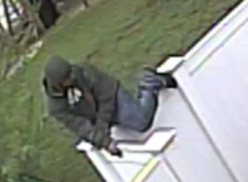 A suspect is seen climbing a homeowner's fence to break into a Bustleton property. Image/Philadelphia Police