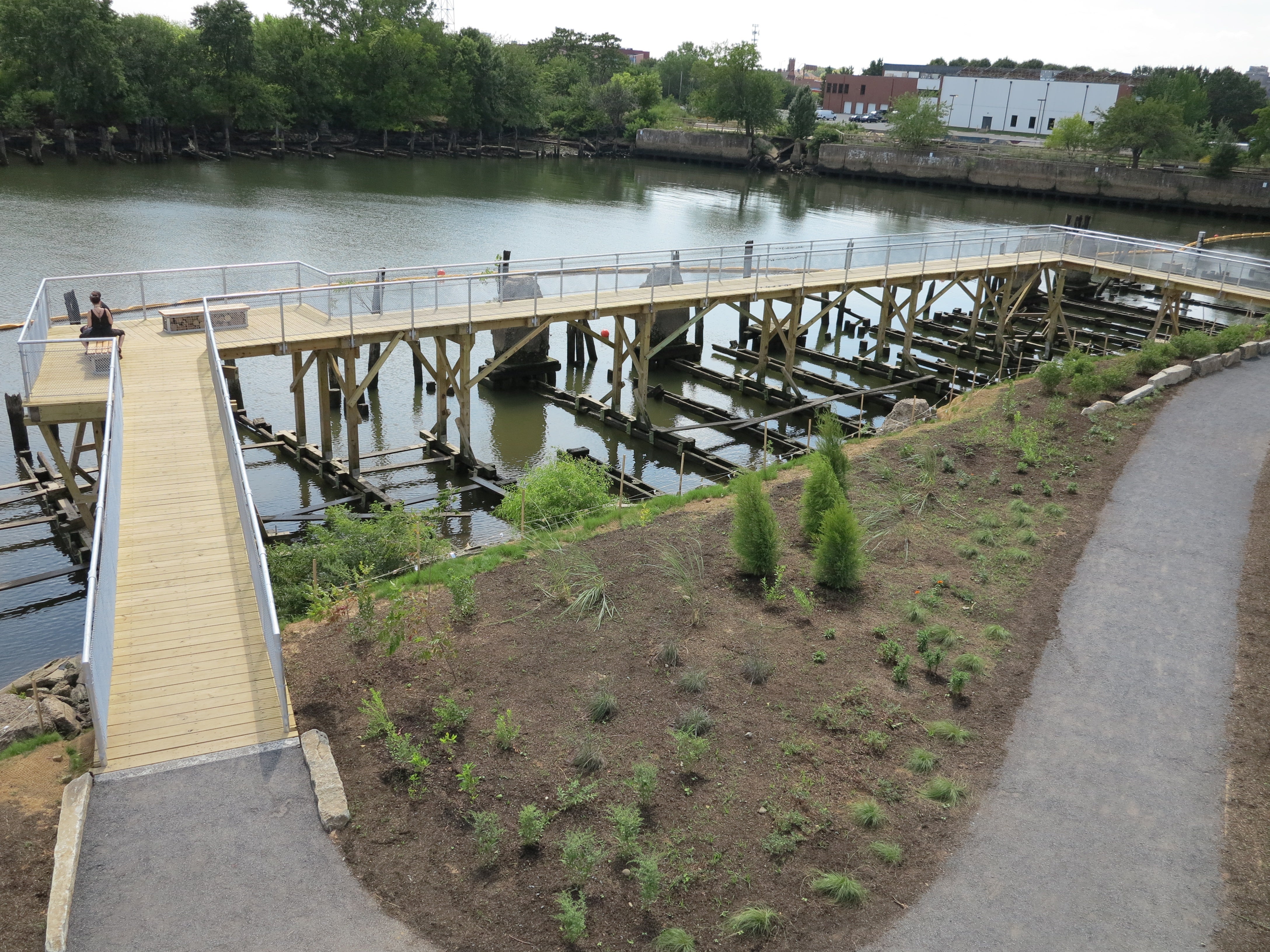 An elevated boardwalk extends the pier over the water