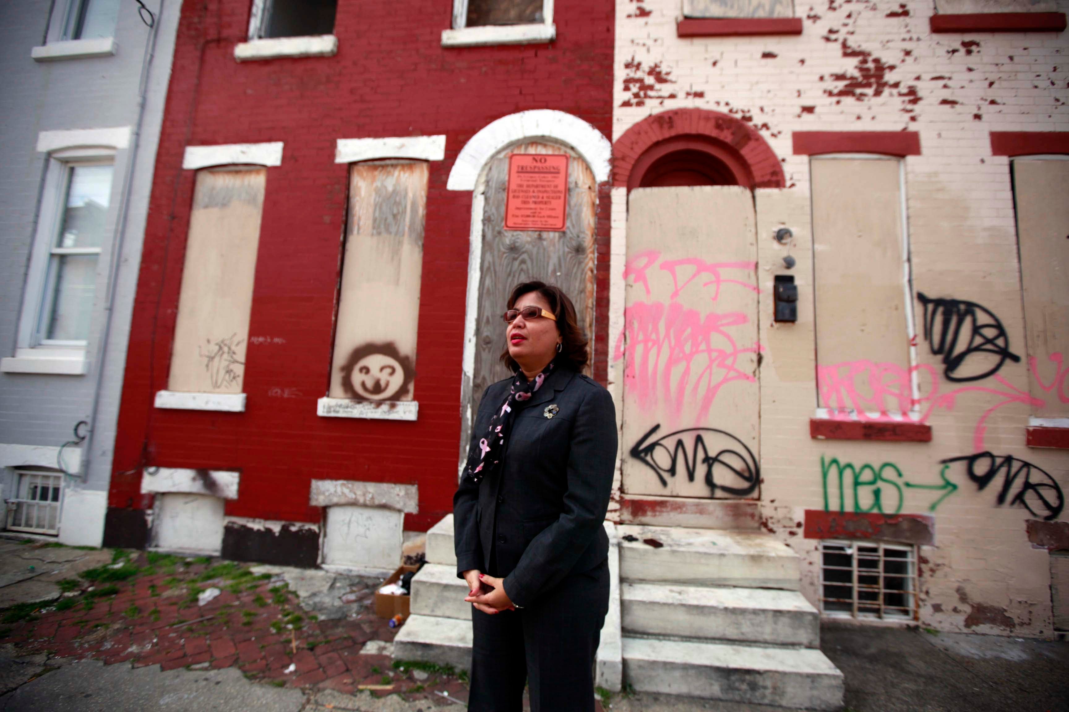 This 2013 photo shows Councilwoman Maria Quiñones-Sánchez stands in front of a blighted home in her district.