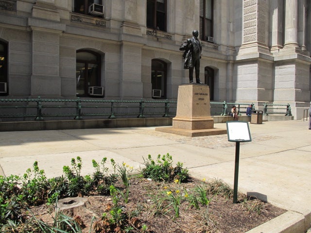 East Apron: John Wannamaker statue stands alone, people pull up some plinth for seating, and a dead tree needs replacement.