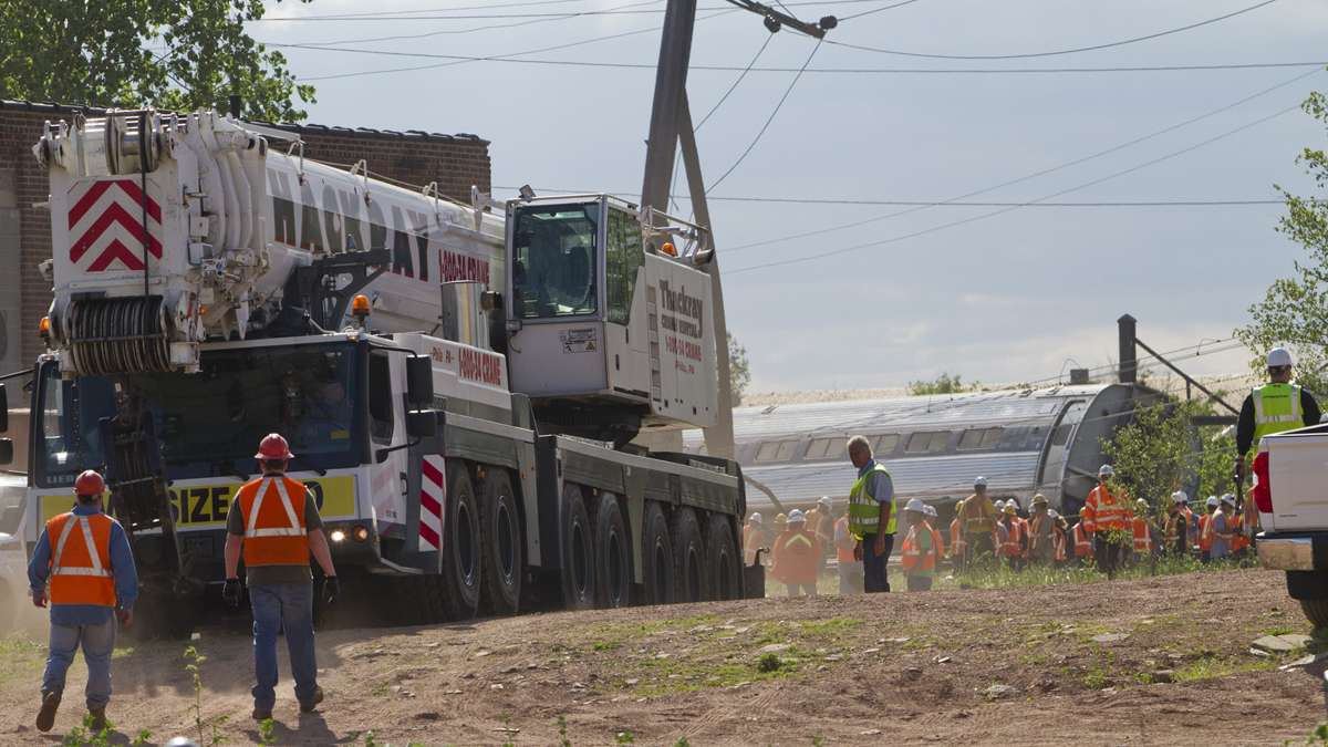 Emergency personnel bring in a crane to move the derailed Amtrak train near Port Richmond in North Philadelphia Wednesday morning.