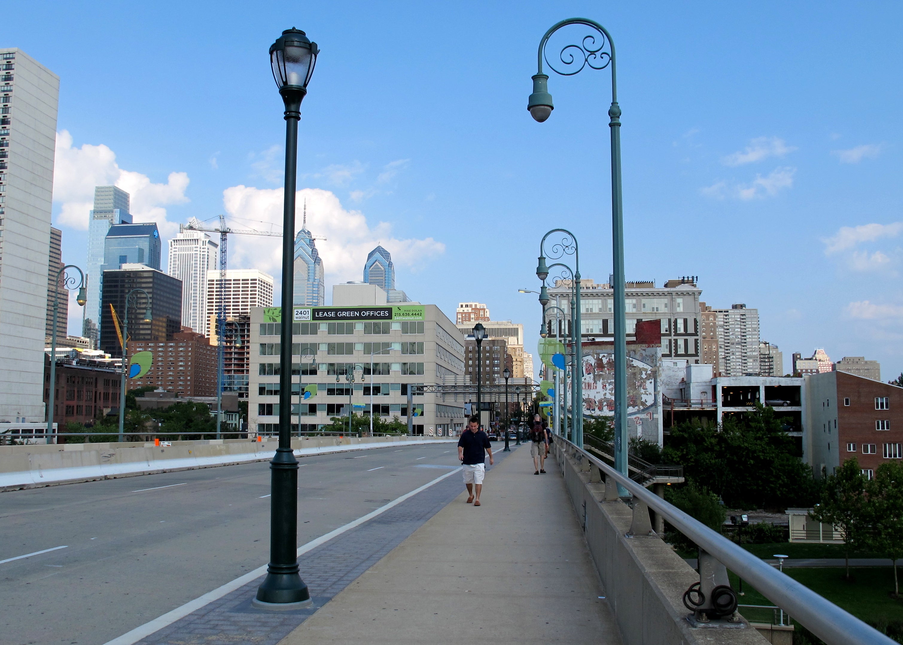 The redesigned Walnut Street Bridge has wider sidewalks, better pedestrian lighting, and (soon) a buffered bike lane. Construction will be finished this week.