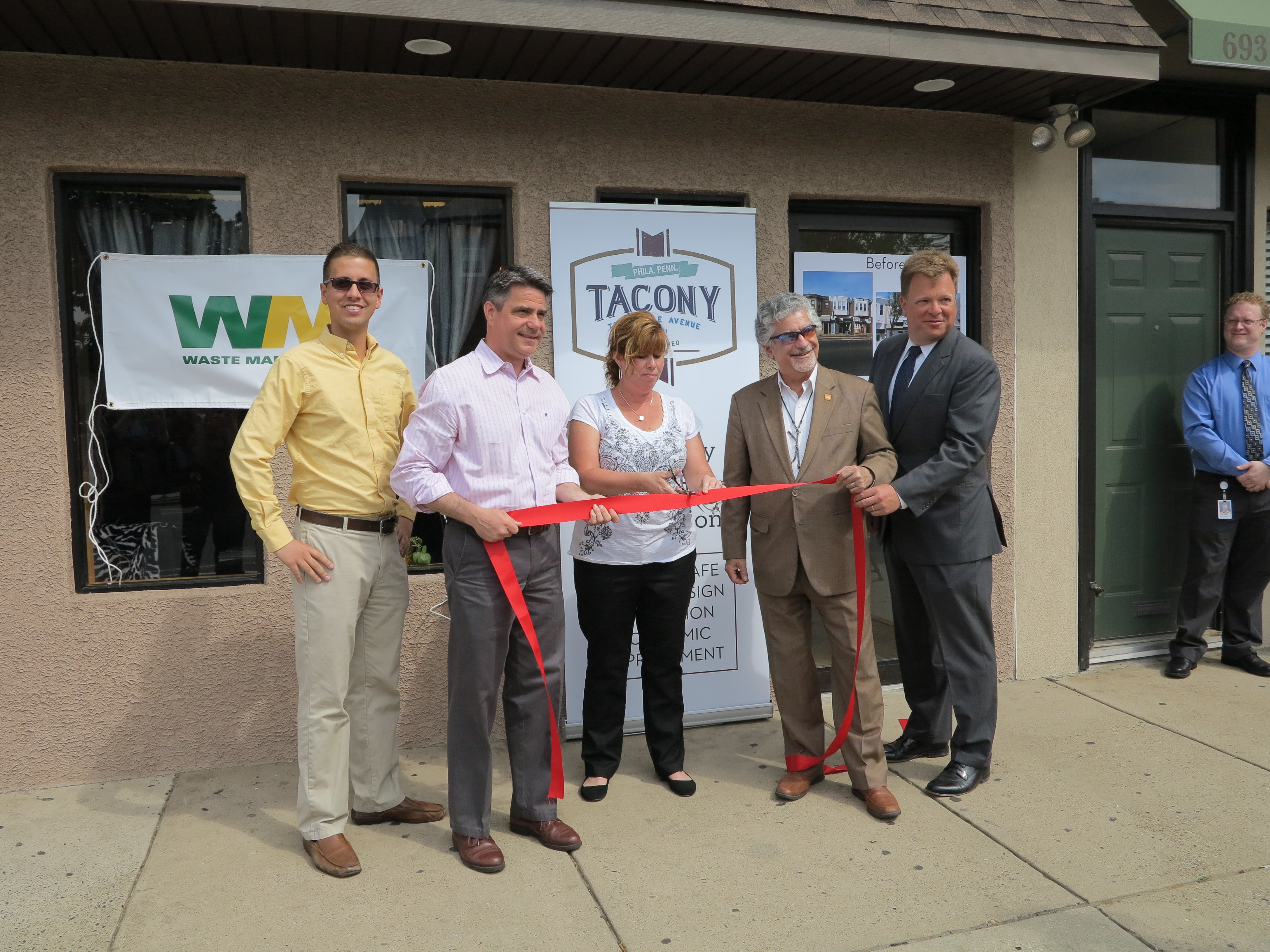 Tacony CDC's Alex Balloon, Councilman Bobby Henon, business owner Georgeanne Huff-Labovitz, Deputy Mayor Alan Greenberger, Waste Management’s Jim Van Woert celebrate Tacony's 15 renovated storefronts