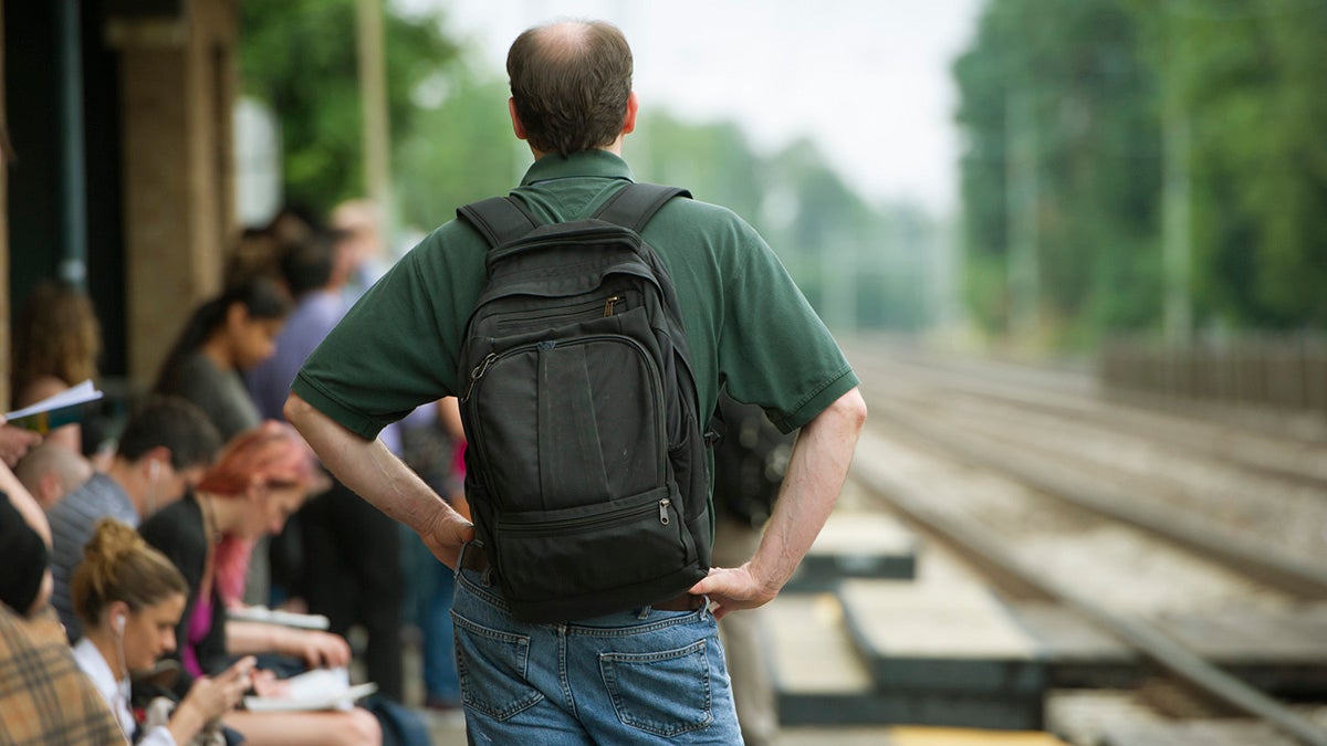 A passenger waits at the Ardmore Station for a train to Philadelphia. SEPTA trains are running on a modified Saturday schedule. (Jonathan Wilson for Newsworks)