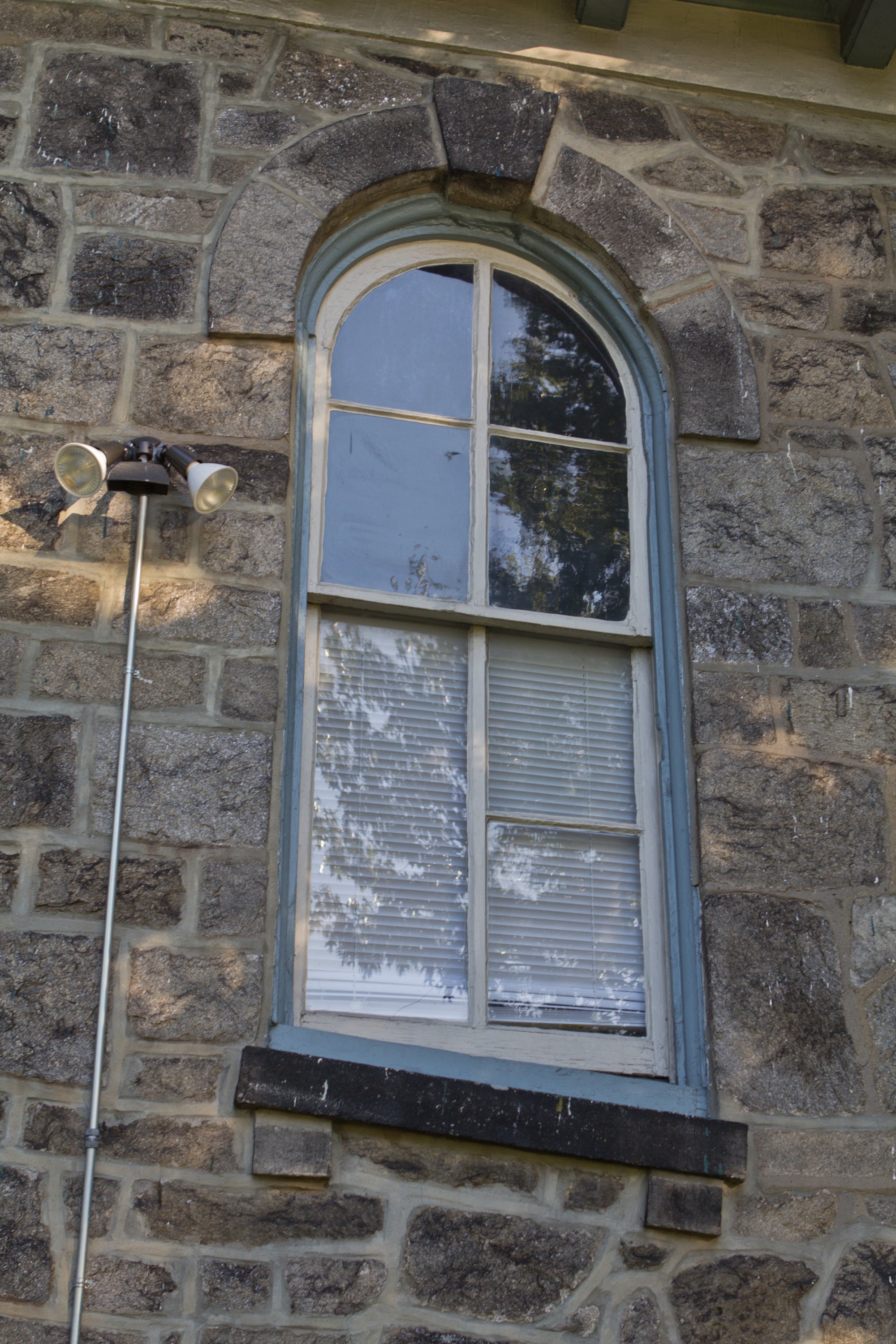 A stream beneath the Philadelphia Girls' Rowing Club caused the building to sink, displacing this window years ago. (Kimberly Paynter/WHYY)