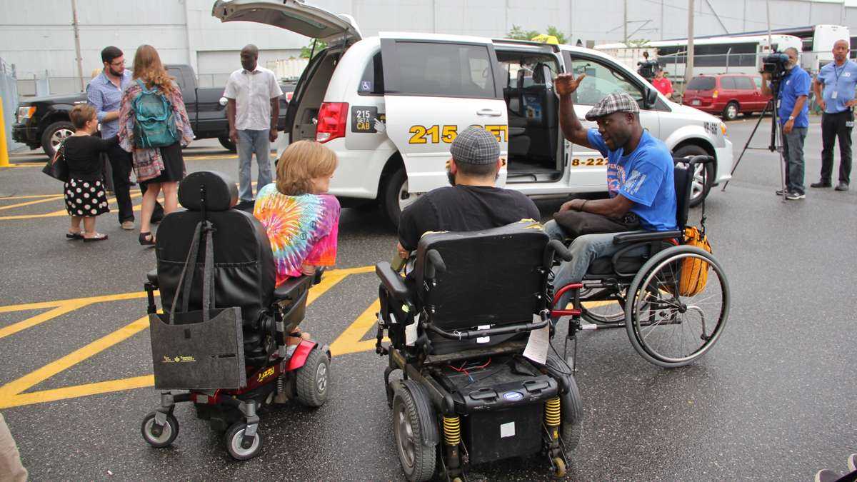 Accessibility activists gather on July 2 to witness Philadelphia's introduction of new wheelchair accessible taxis. (Emma Lee/WHYY)
