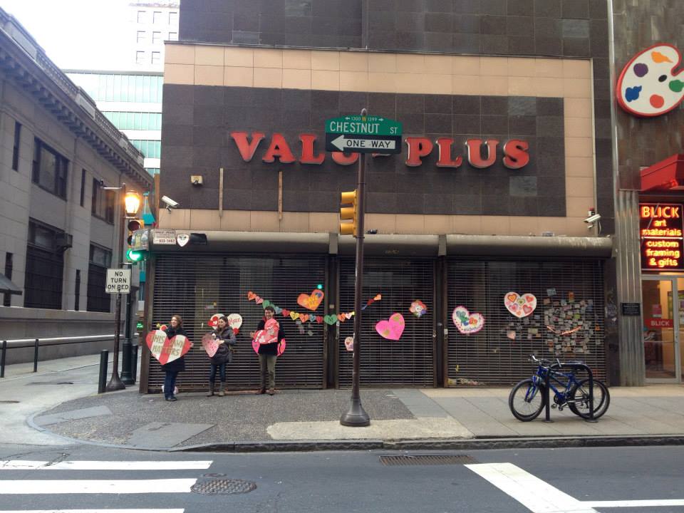 (From left) Lauren Drapala, Lynn Alpert and Harrison Haas at the “heart bombing” in front of the Hale Building, February 2015 | Libbie Hawes.