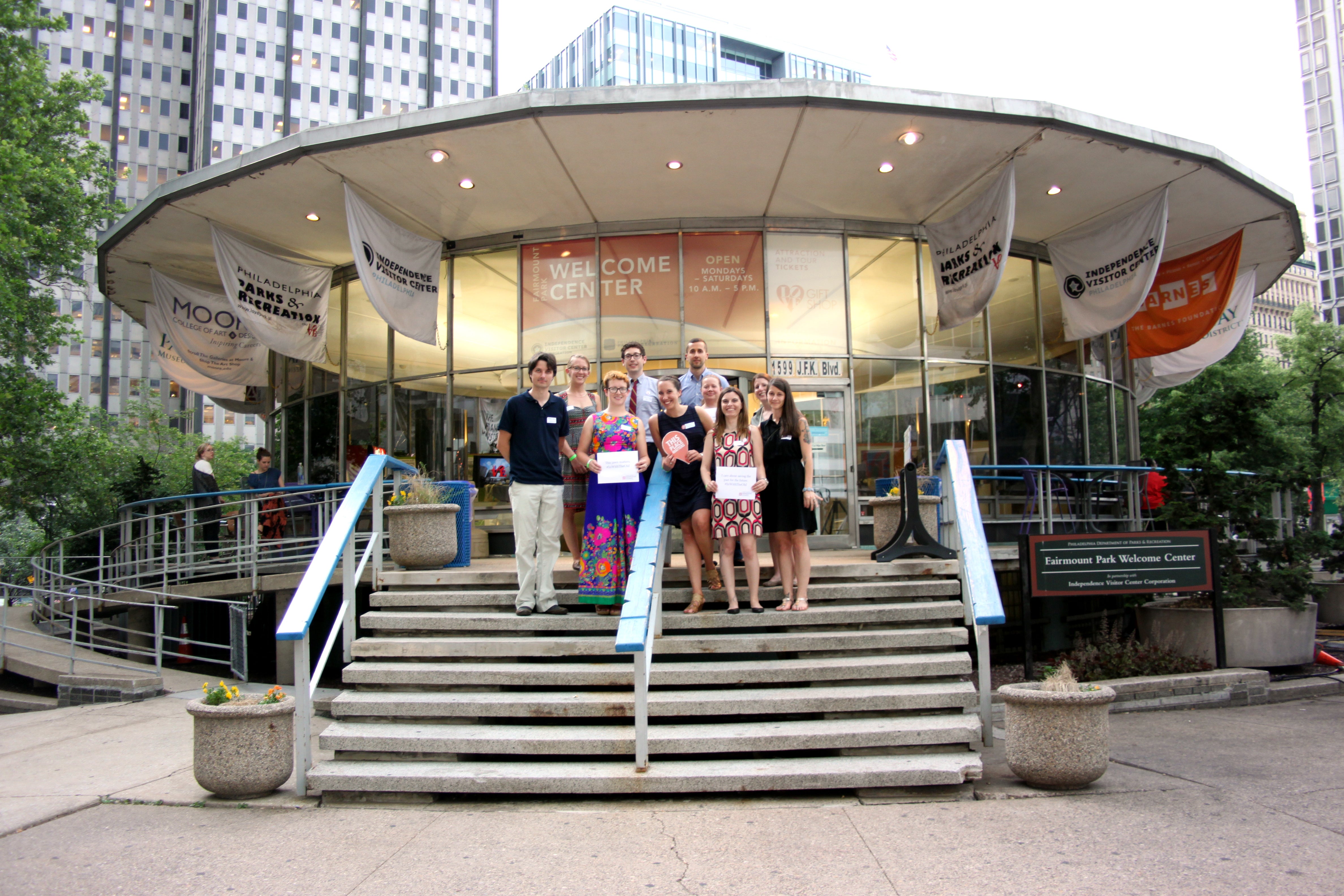 Members of the Young Friends steering committee on the steps of the Welcome Center in LOVE Park, May 2015: (from left, top row) Lindsey Allen, Harrison Haas, Kevin McMahon; (bottom row) Andrew Hart, Meg Kelly, Molly Lester, Libbie Hawes, Lynn Alpert, Amy McCollum Ricci, and Allee Berger. | Lauren Drapala.