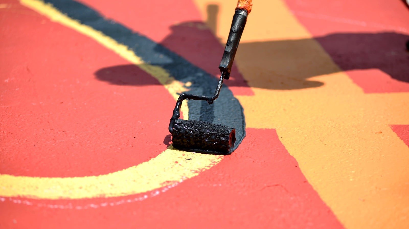 Rollers in various sizes are used to apply the paint. (Bastiaan Slabbers for NewsWorks)