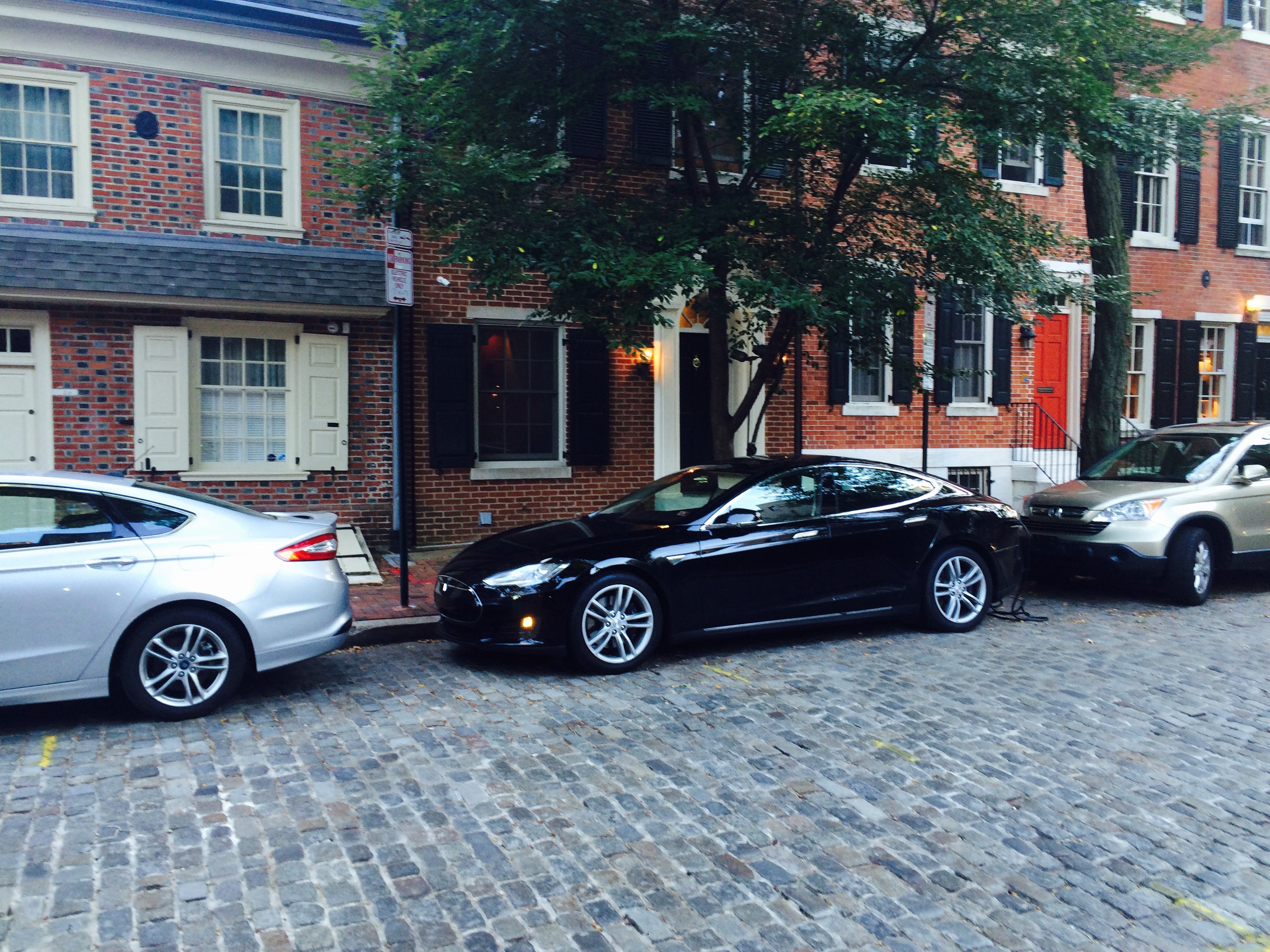 Tesla plugged in at the EV-only zone on Delancey Street.