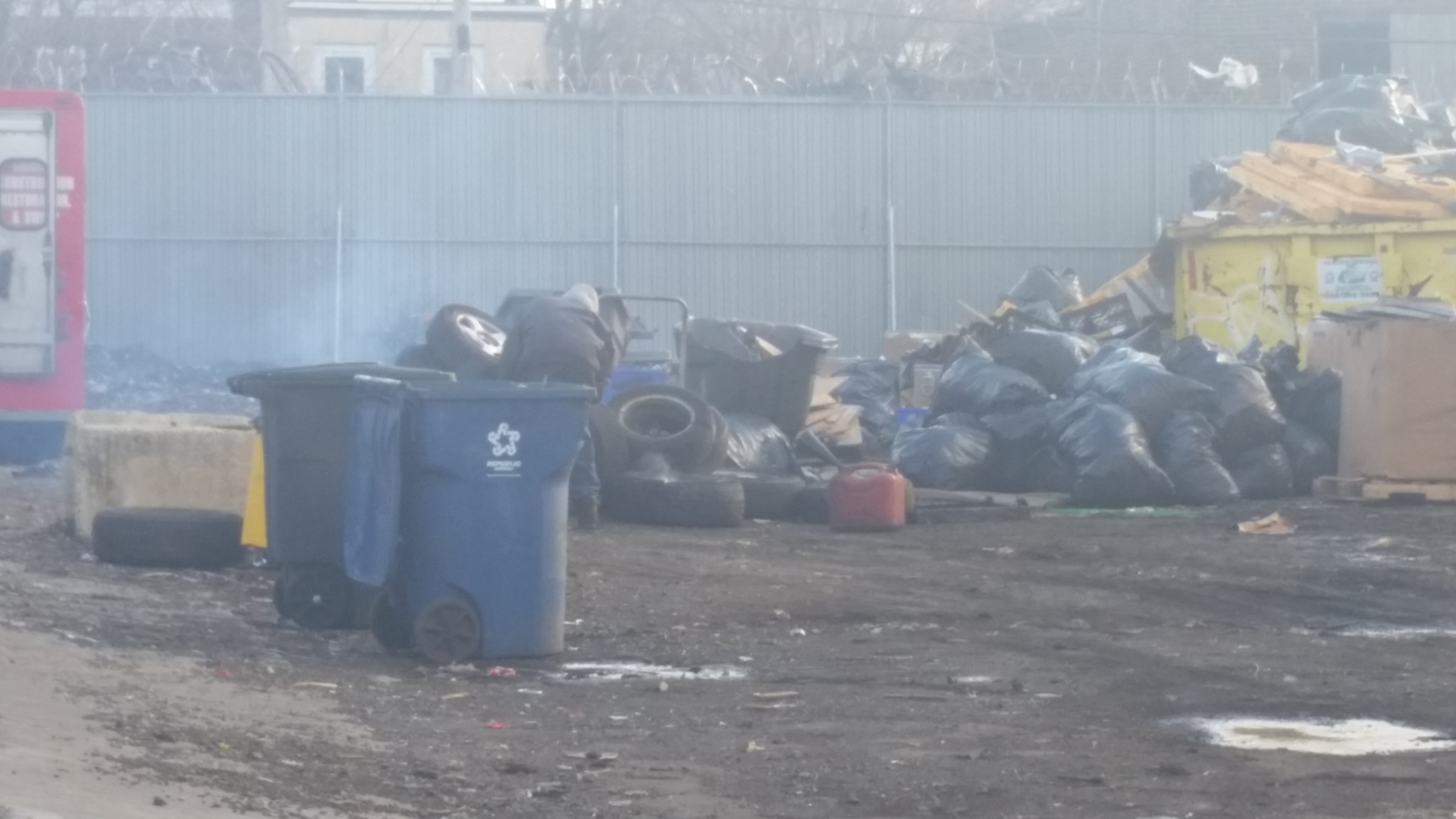 Worker of Philadelphia Scrap Metal cutting tires | Genevieve Geer