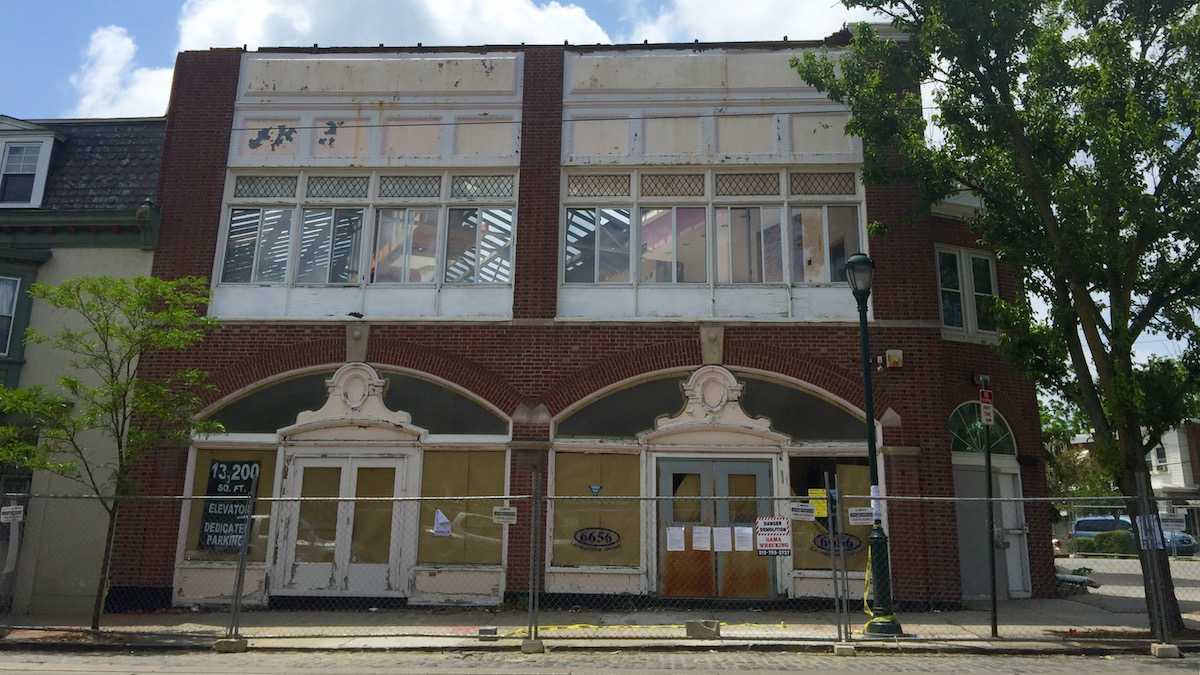 A demolition crew tore down the roof of a historic building at 6656-62 Germantown Ave. in Mt. Airy to make way for the Westview luxury apartments in 2015. Credit: Jana Shea/WHYY