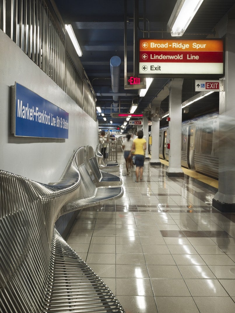 Curved metal benches at the 8th Street SEPTA subway station