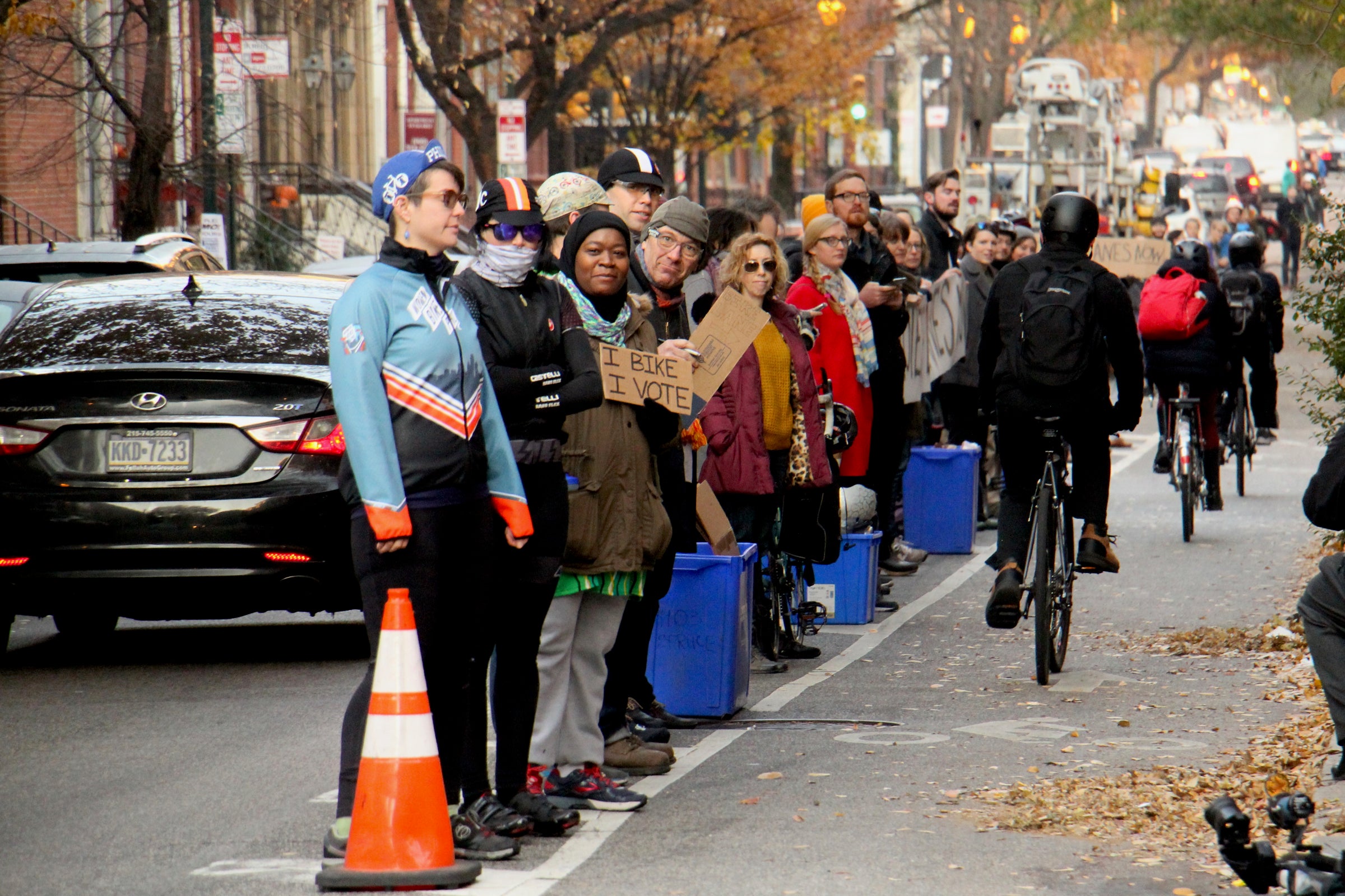 Cyclists form a human-protected bike lane along Spruce Street on Nov. 29, 2017, one day after Emily Fredricks was struck and killed on the street.