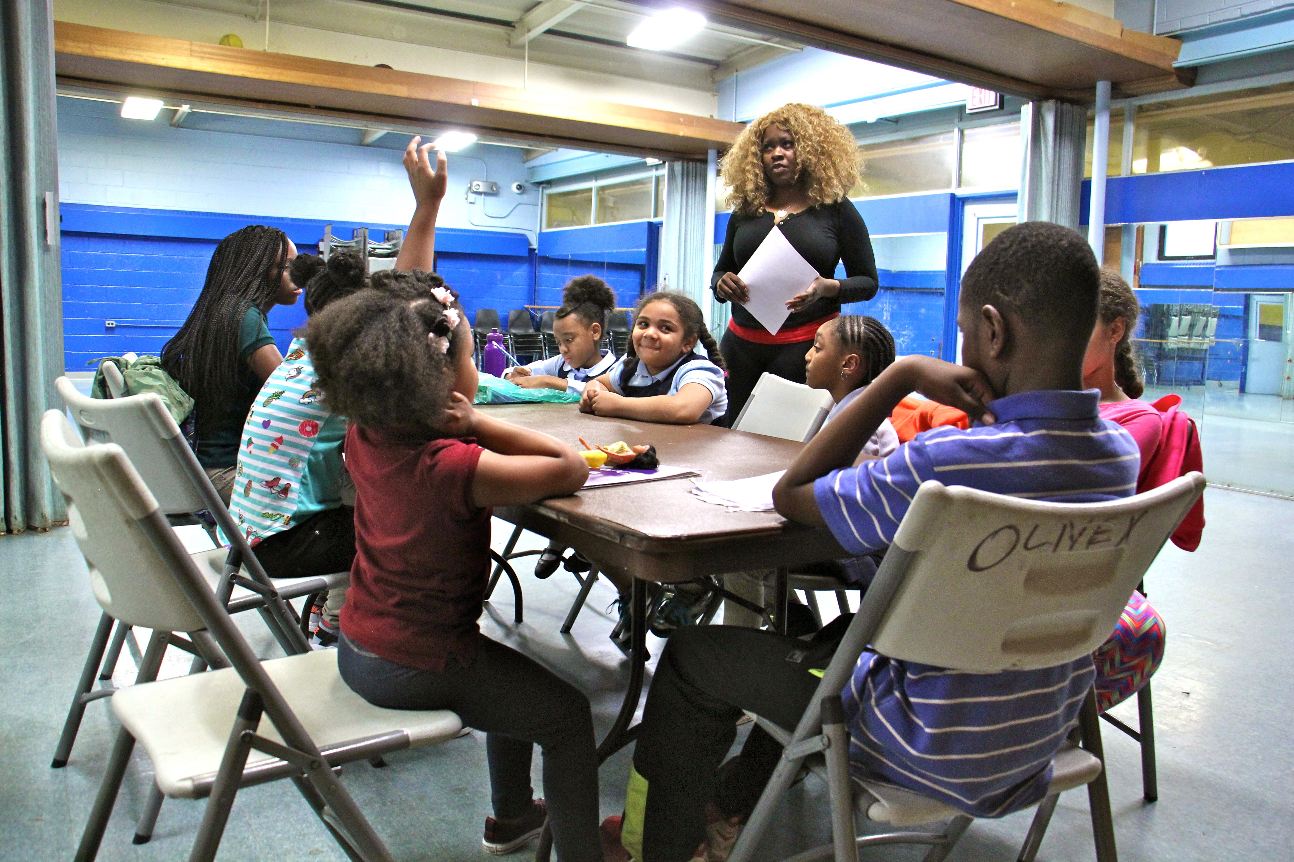 Drama teacher Star Parker gathers her students for a discussion before starting rehearsal at Olney Rec Center. The group addresses issues like bullying in their performances. (Emma Lee/WHYY)