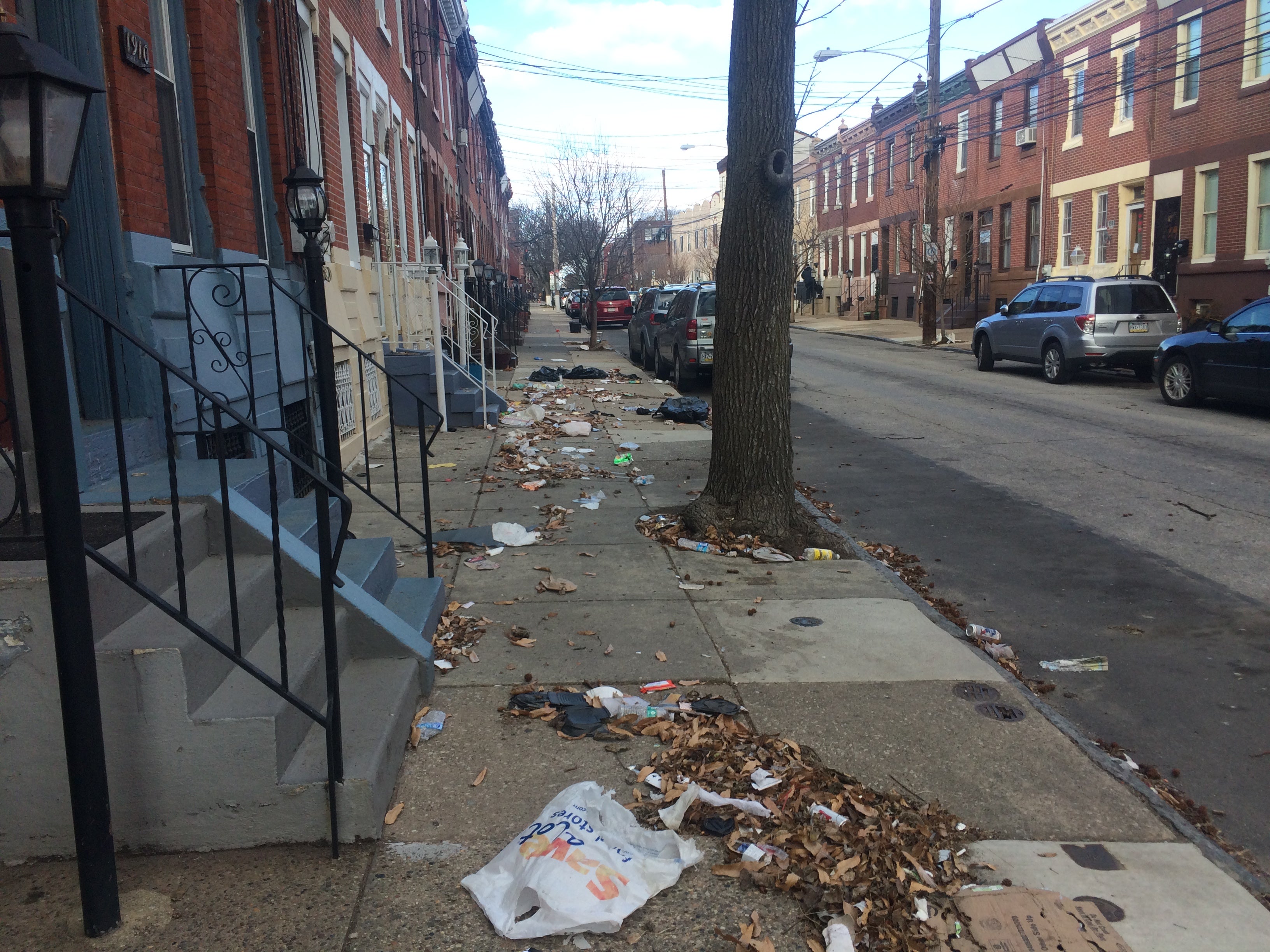 The plan recommends giving away lidded recycling bins to prevent trash flying on windy days