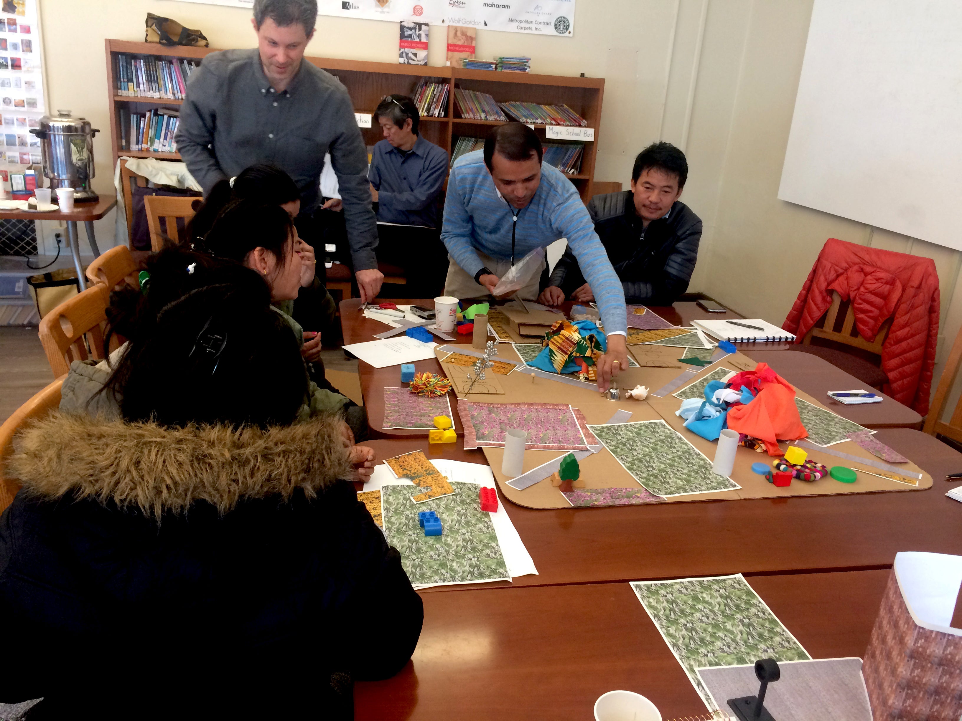 Neighbors creating model of Mifflin Square Park during 2017 civic engagement session. 