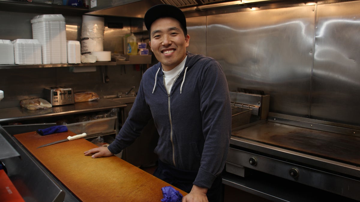 Kipp Choe, whose family has owned Martin's Deli on Kensington Ave. for 25 years, offered adjacent storefronts to Mural Arts believing that it would help the neighborhood. (Emma Lee/WHYY)
