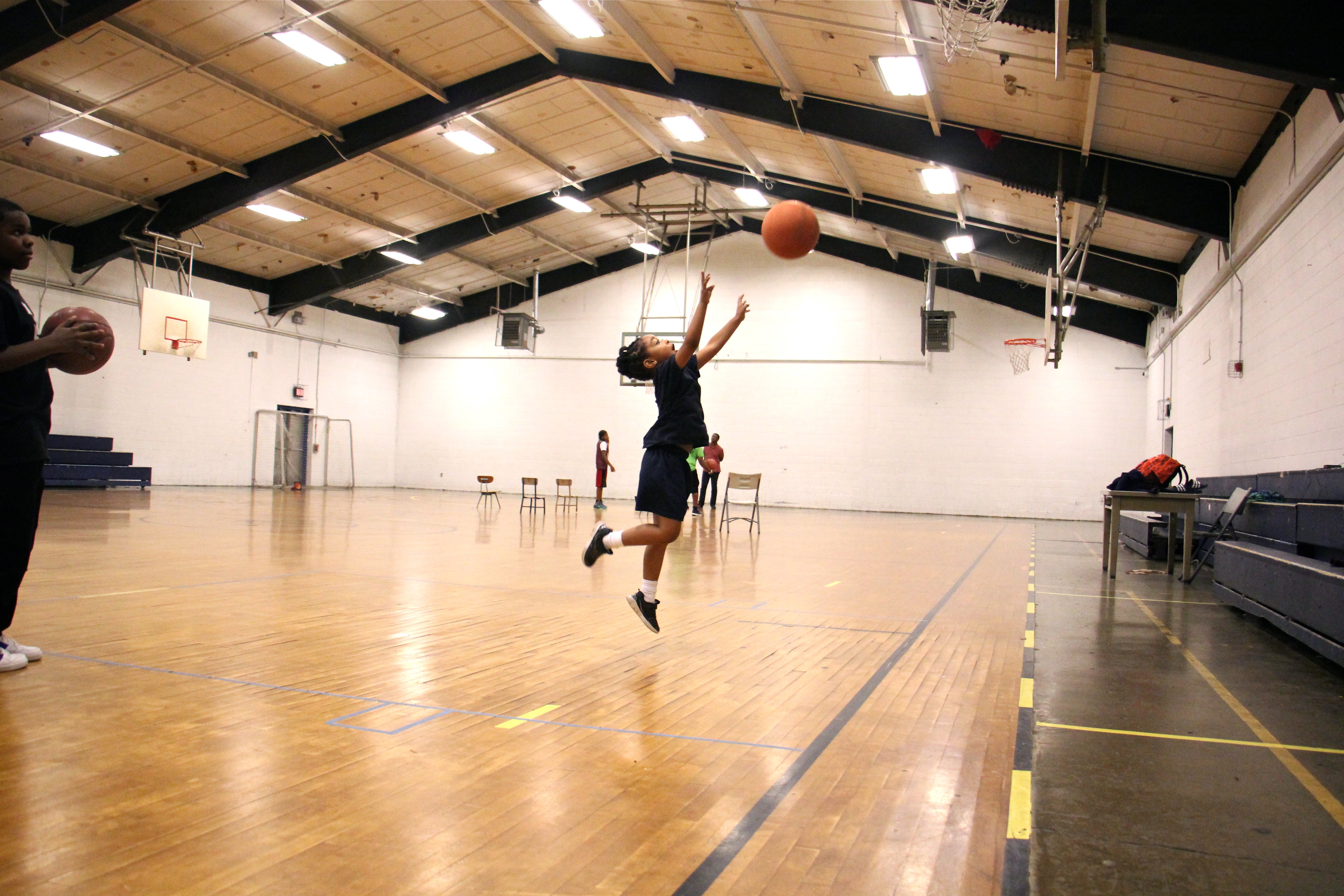 Leilani Jackson, 5, takes plays in the gym during an afterschool program at Olney Rec Center. (Emma Lee/WHYY)