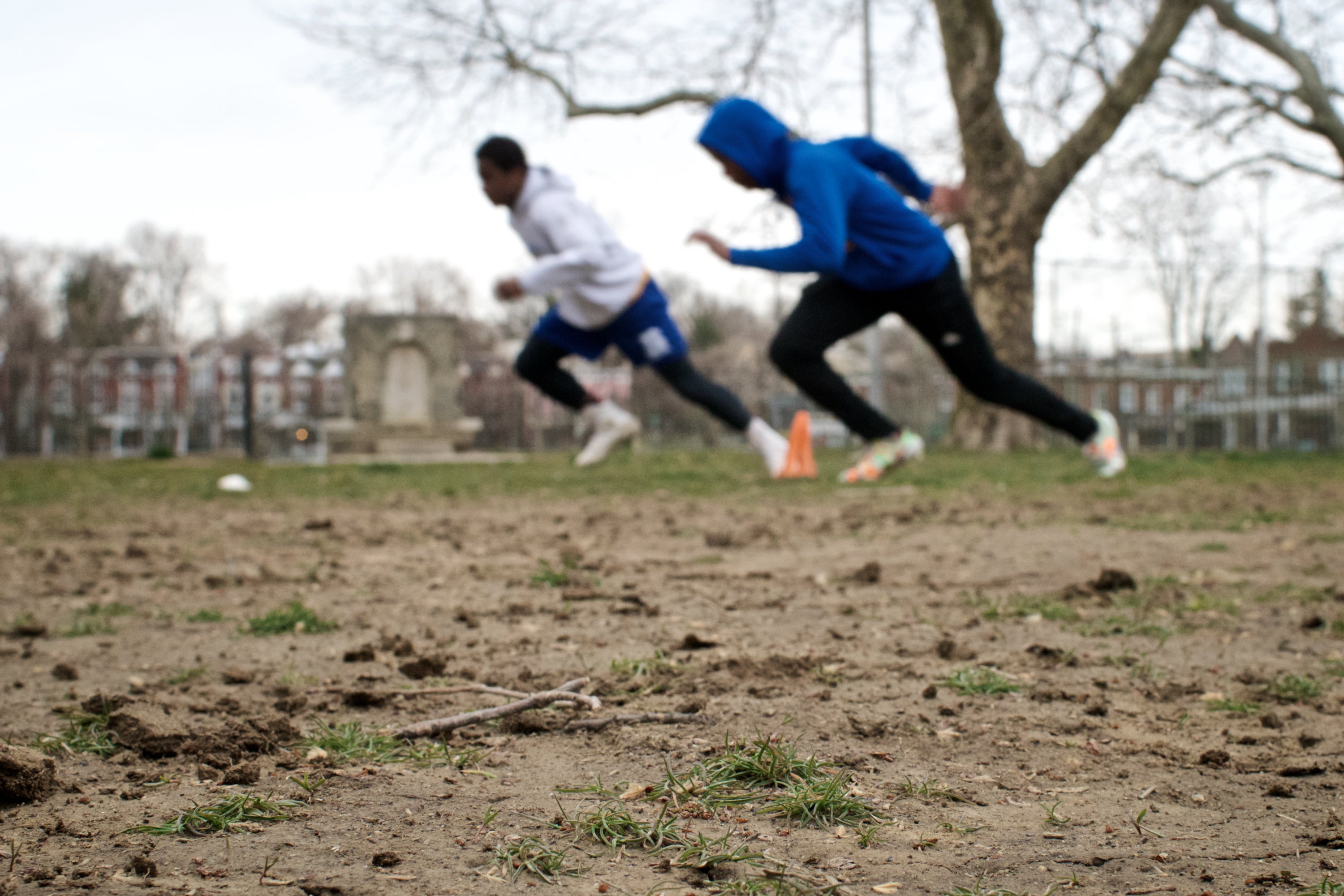 NW Raiders practice on the muddy city-owned football field behind Lonnie Young Rec. Center. (Bastiaan Slabbers for WHYY)