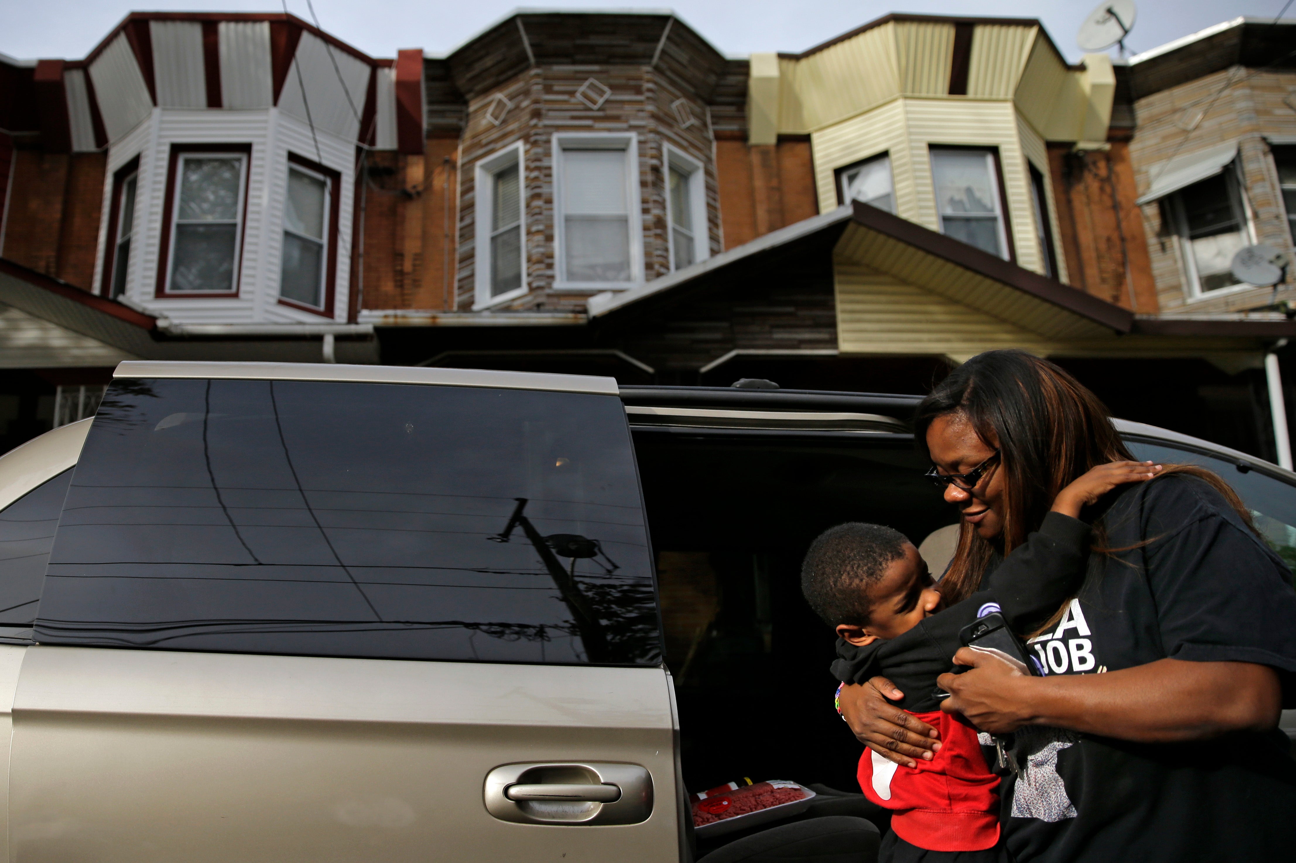 Philadelphia mother and son in front of home