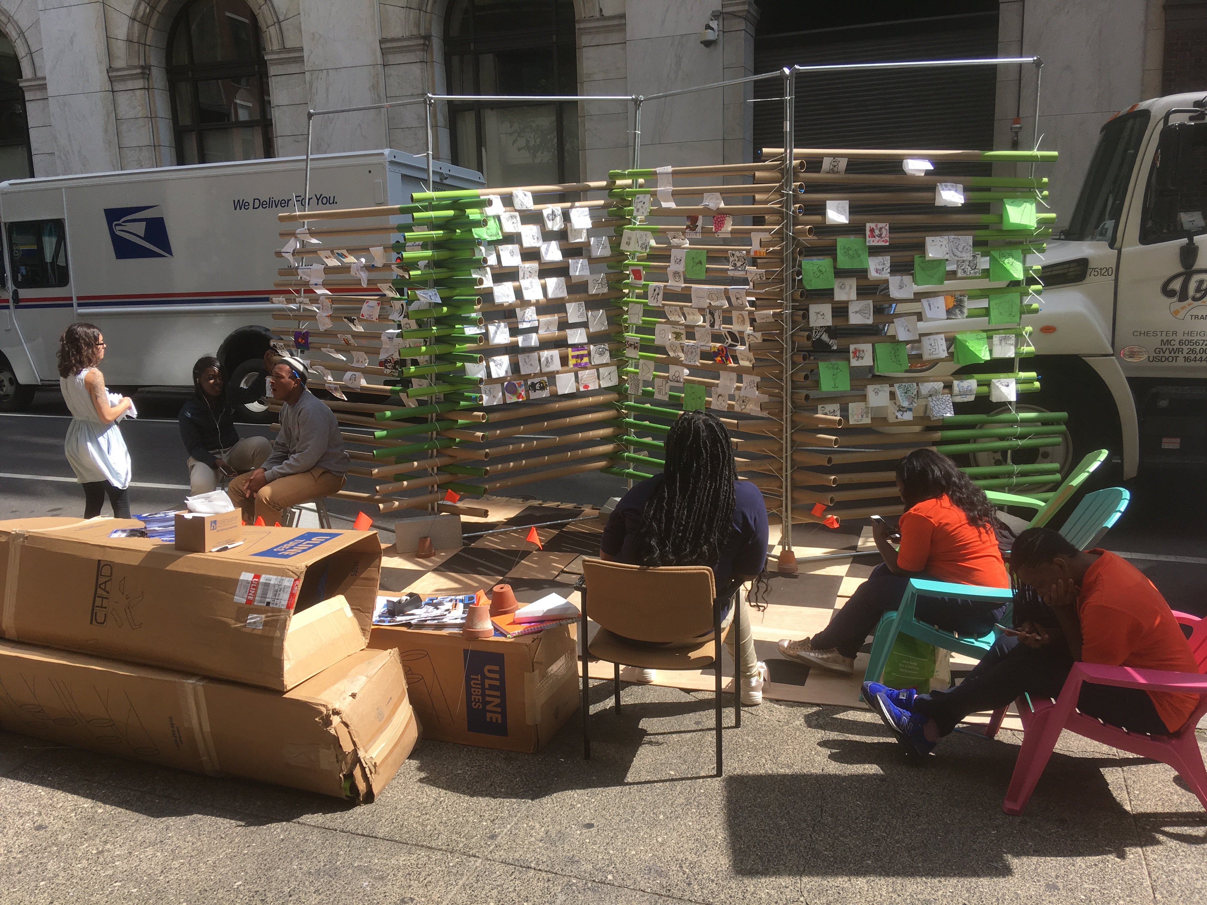 Students from Charter High school for Architecture and Design offer a participatory pop-up art gallery, asking pedestrians to offer their drawings