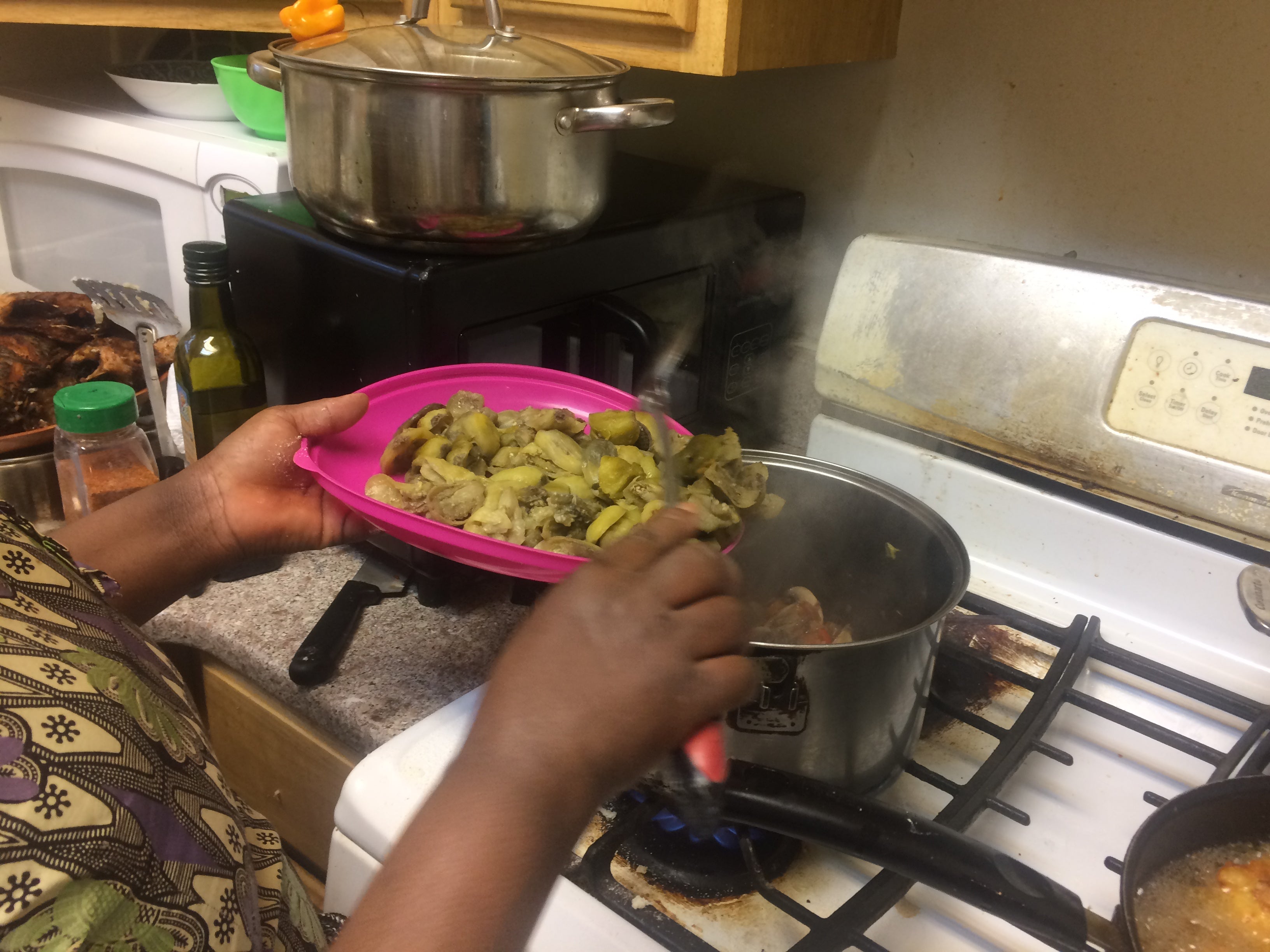 Suzana Muzungu cooking African eggplant. | Catalina Jaramillo / WHYY