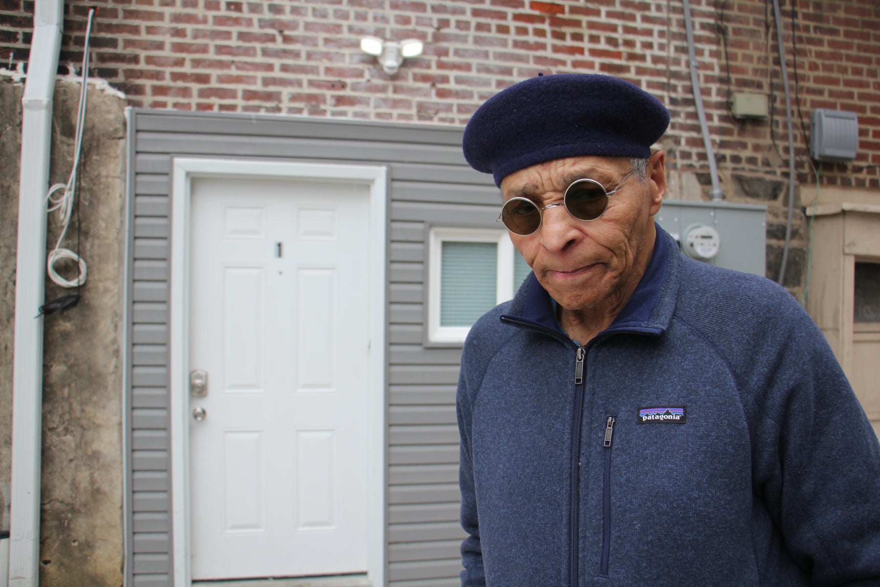 Bailey in front of his new apartment. Credit: Emma Lee/WHYY