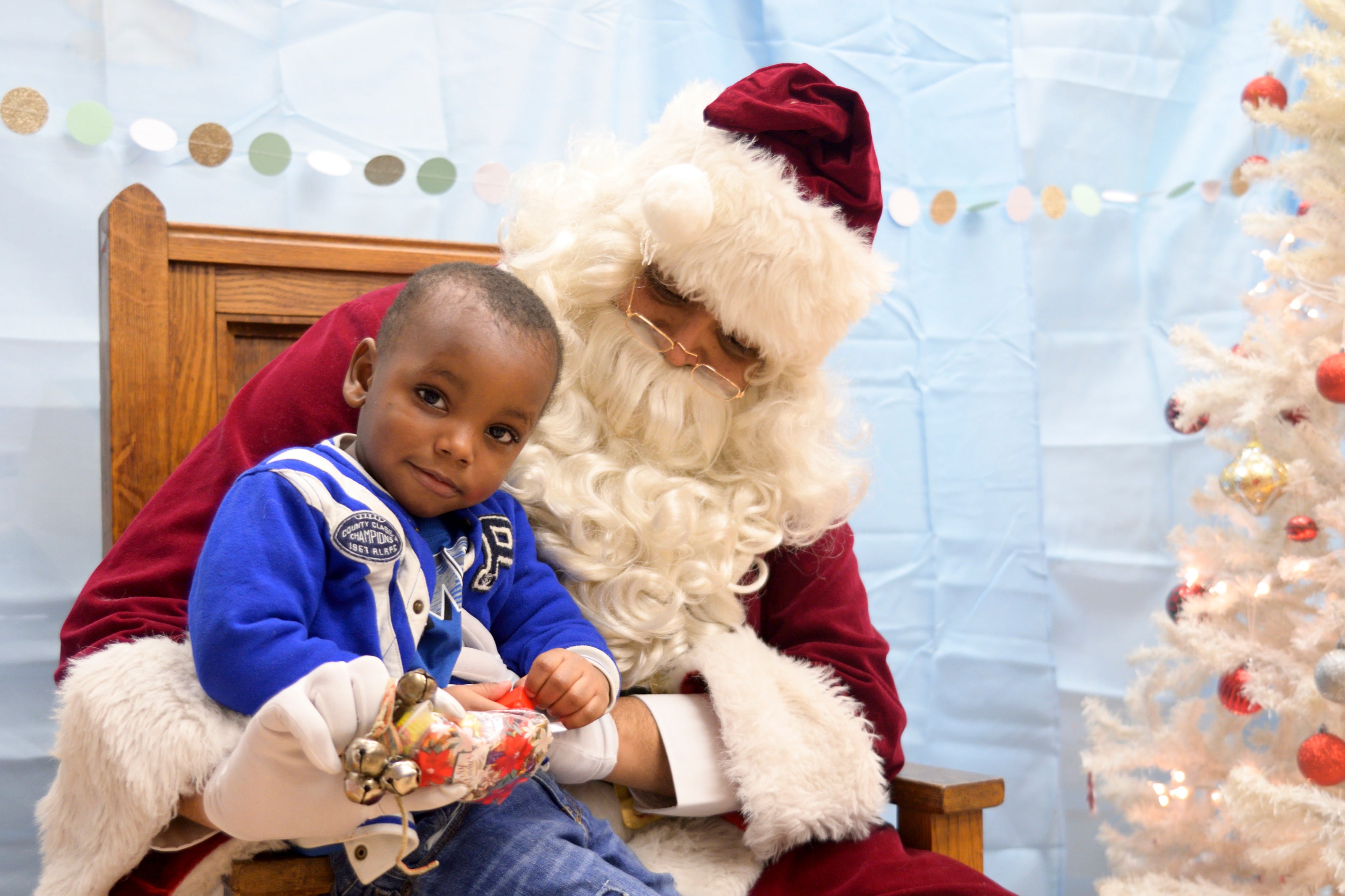 A young boy gets his picture with Santa and the Annual Winter Festival in Olney. Bas Slabbers/WHYY.