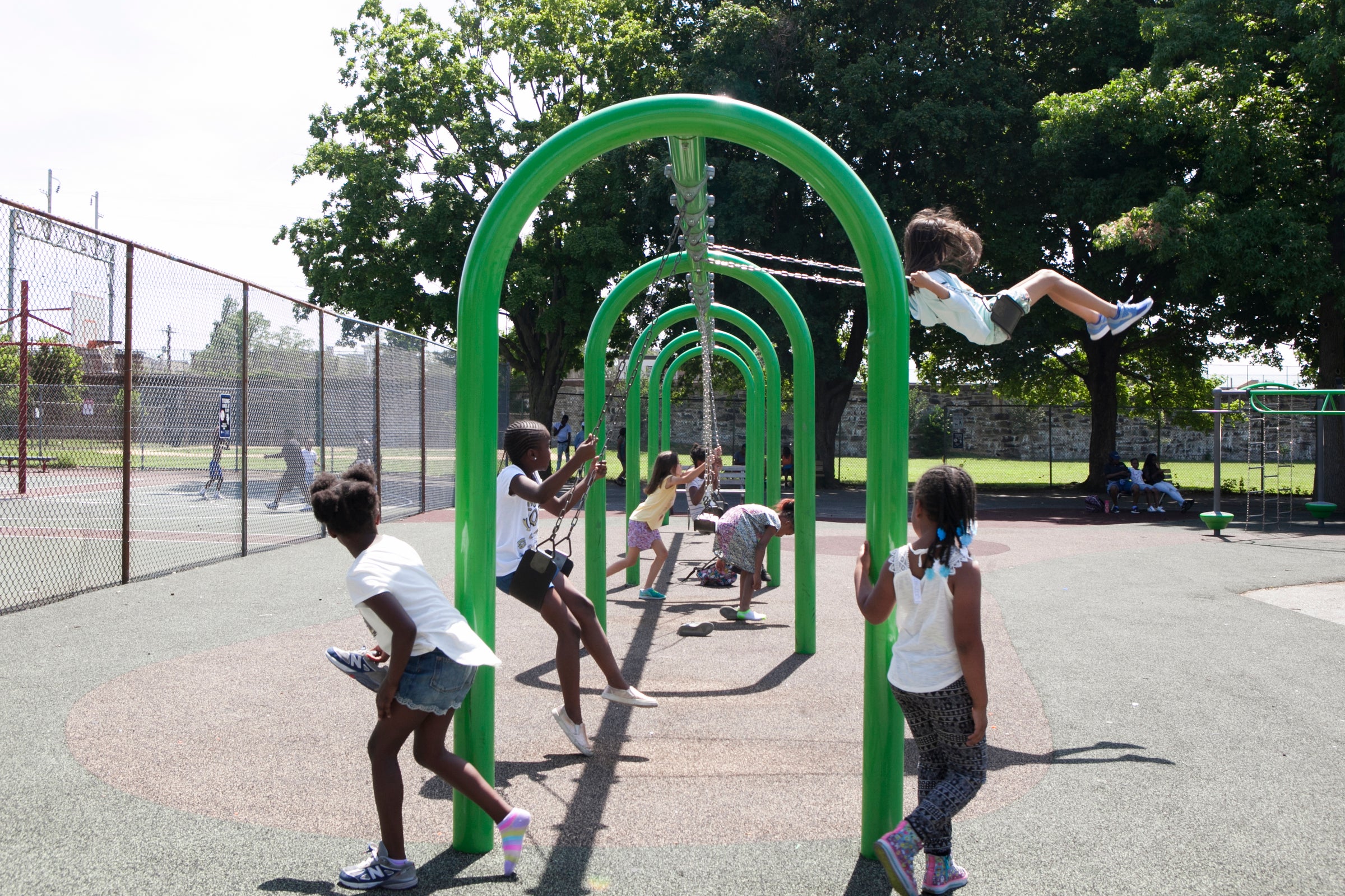 Camp kids play on the swings on the morning of June 29. | Maggie Loesch for PlanPhilly           