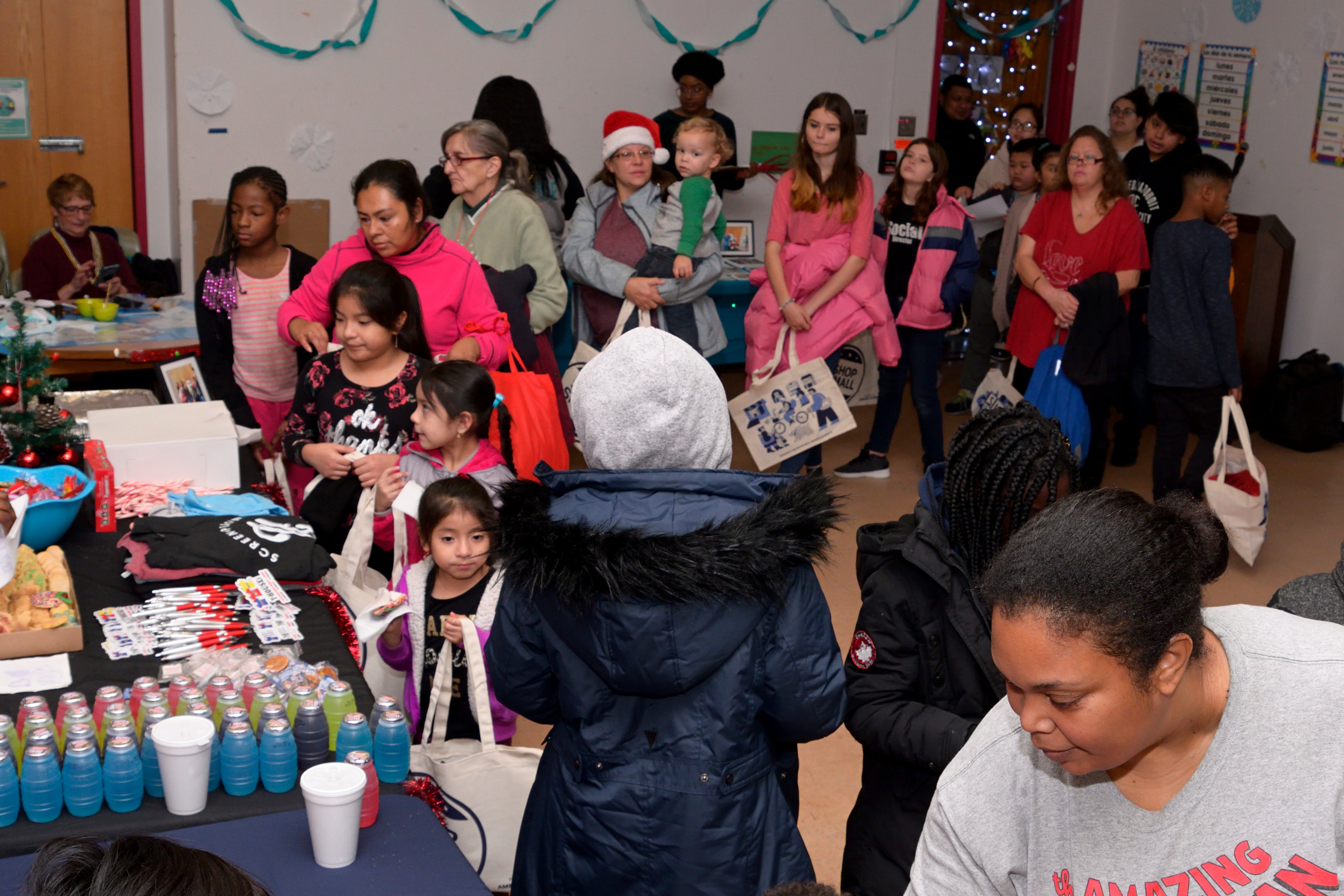 Families line up for toys, snacks, and games at the Annual Winter Festival in Olney. Bas Slabbers/WHYY