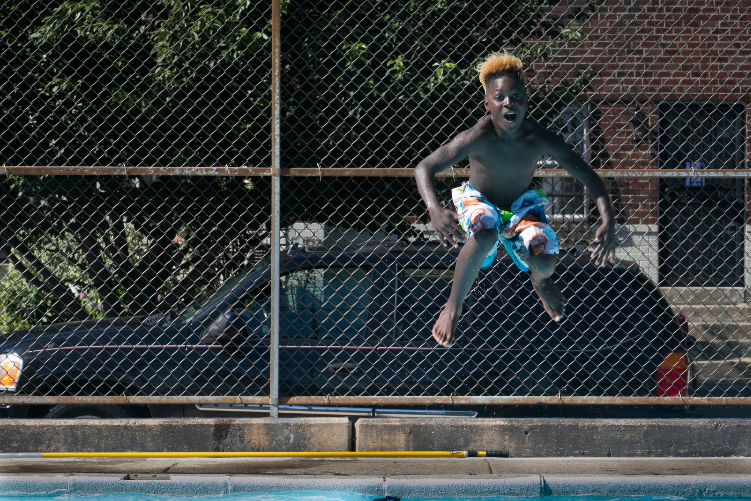 Quamir Jones does a cannonball into the pool at Dendy Playground, at 10th and Oxford streets in North Philadelphia. 