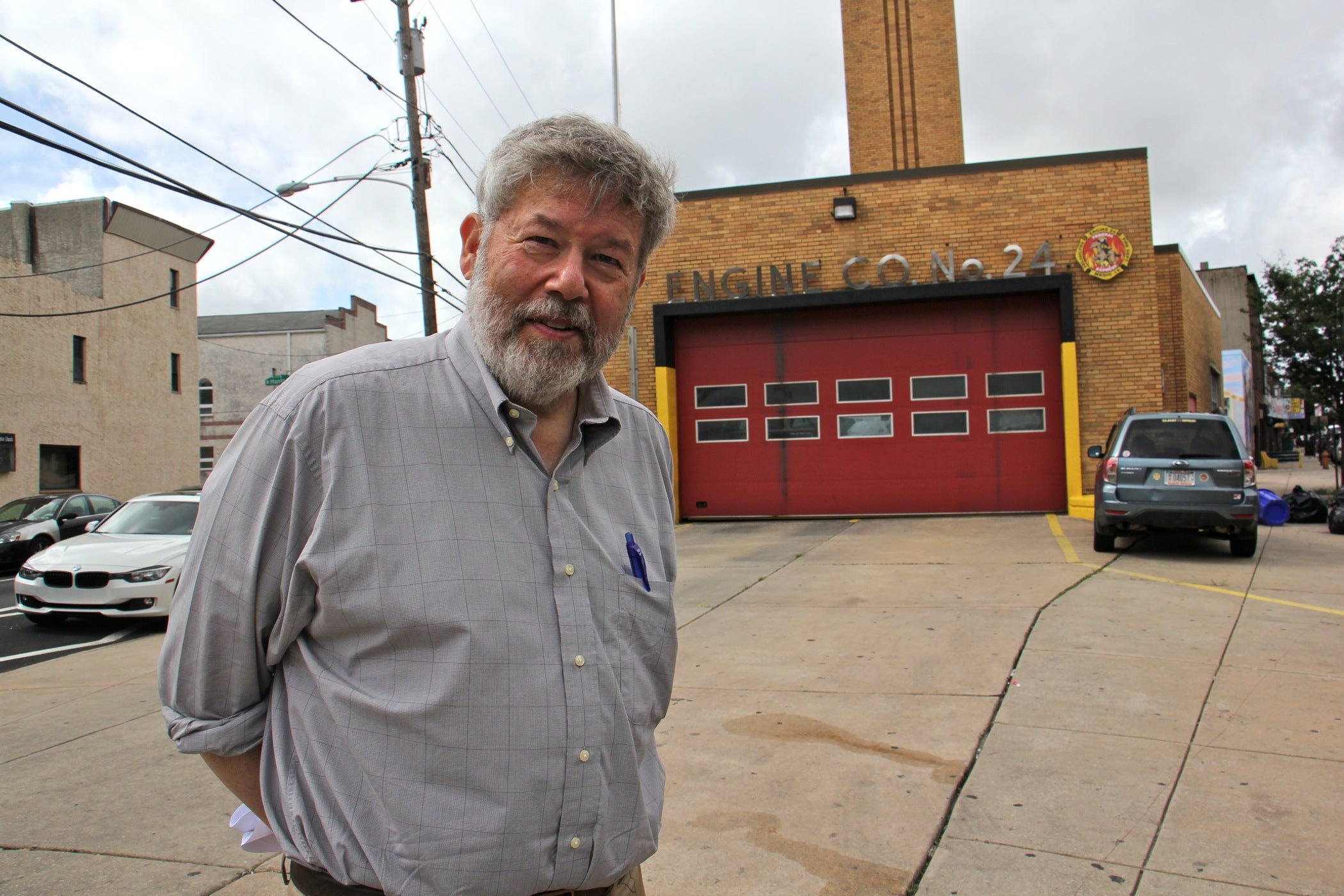 Ken Finkel, a professor of history at Temple University, stands at Point Breeze Avenue and 20th Street, the site of the police station where Riley Bullock was shot and killed. | Emma Lee/WHYY