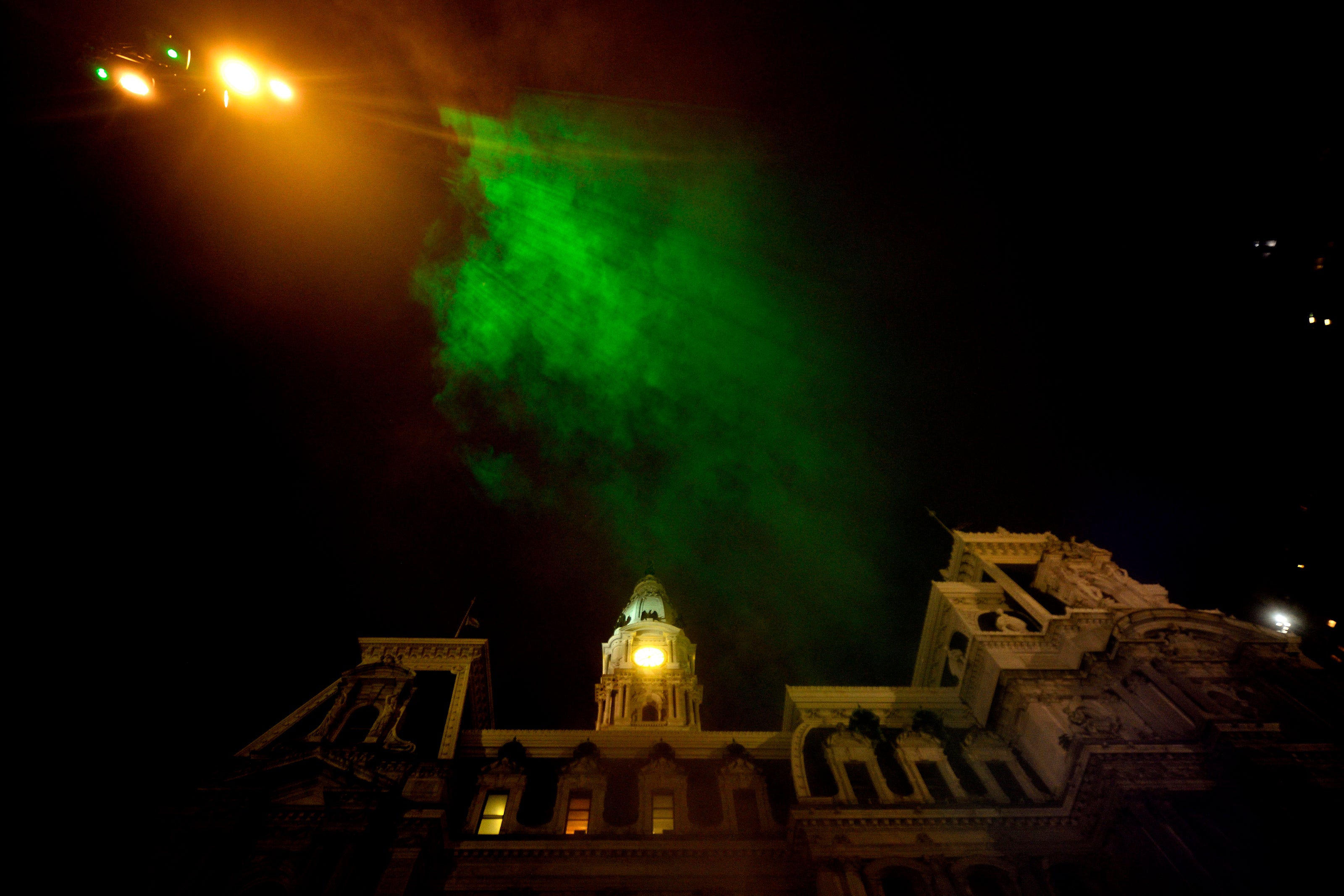 Mist catches green rays of light as it billows up towards the sky during the public unveiling of the first section of the site-specific art installation titled Pulse at the Dilworth Park’s fountain, on Wednesday. (Bastiaan Slabbers for WHYY)