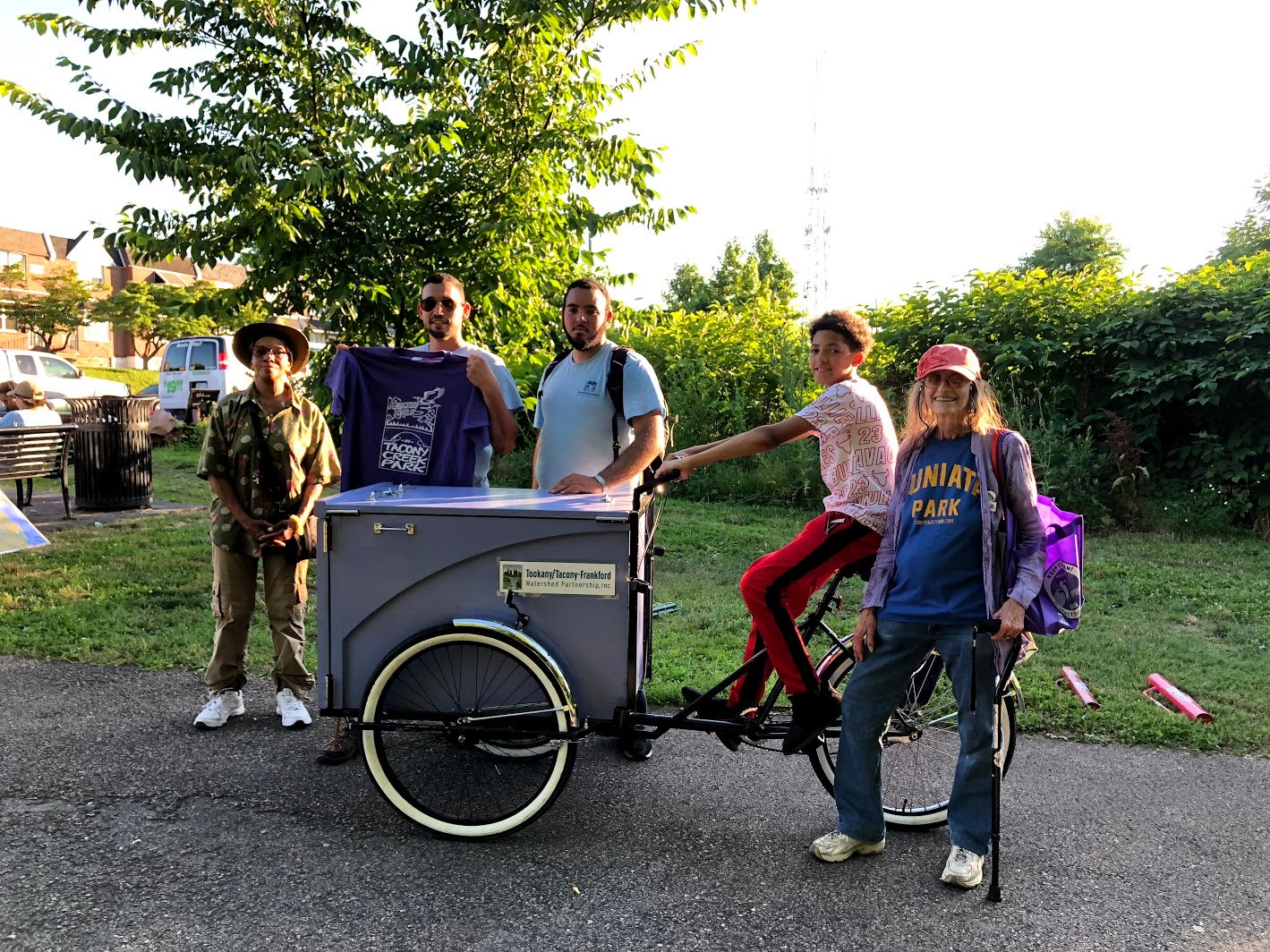 Multiple generations of friends and stewards of Tacony Creek Park, with the 'Creek Mobile.' Credit: Diana Lu/WHYY