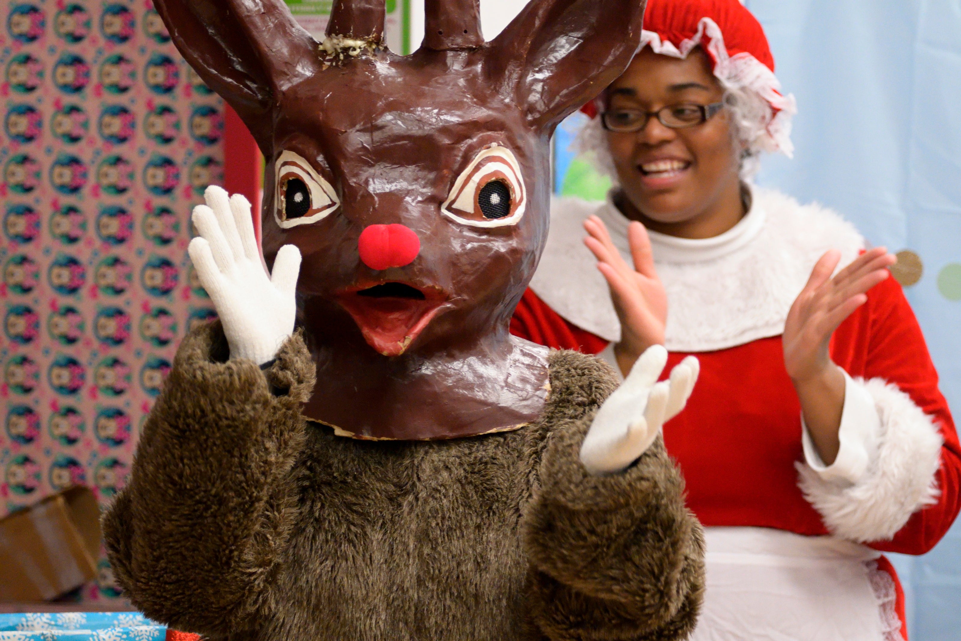 Rudolph and Mrs. Clause clap along to carollers during Annual Winter Festival in Olney. Bas Slabbers/WHYY