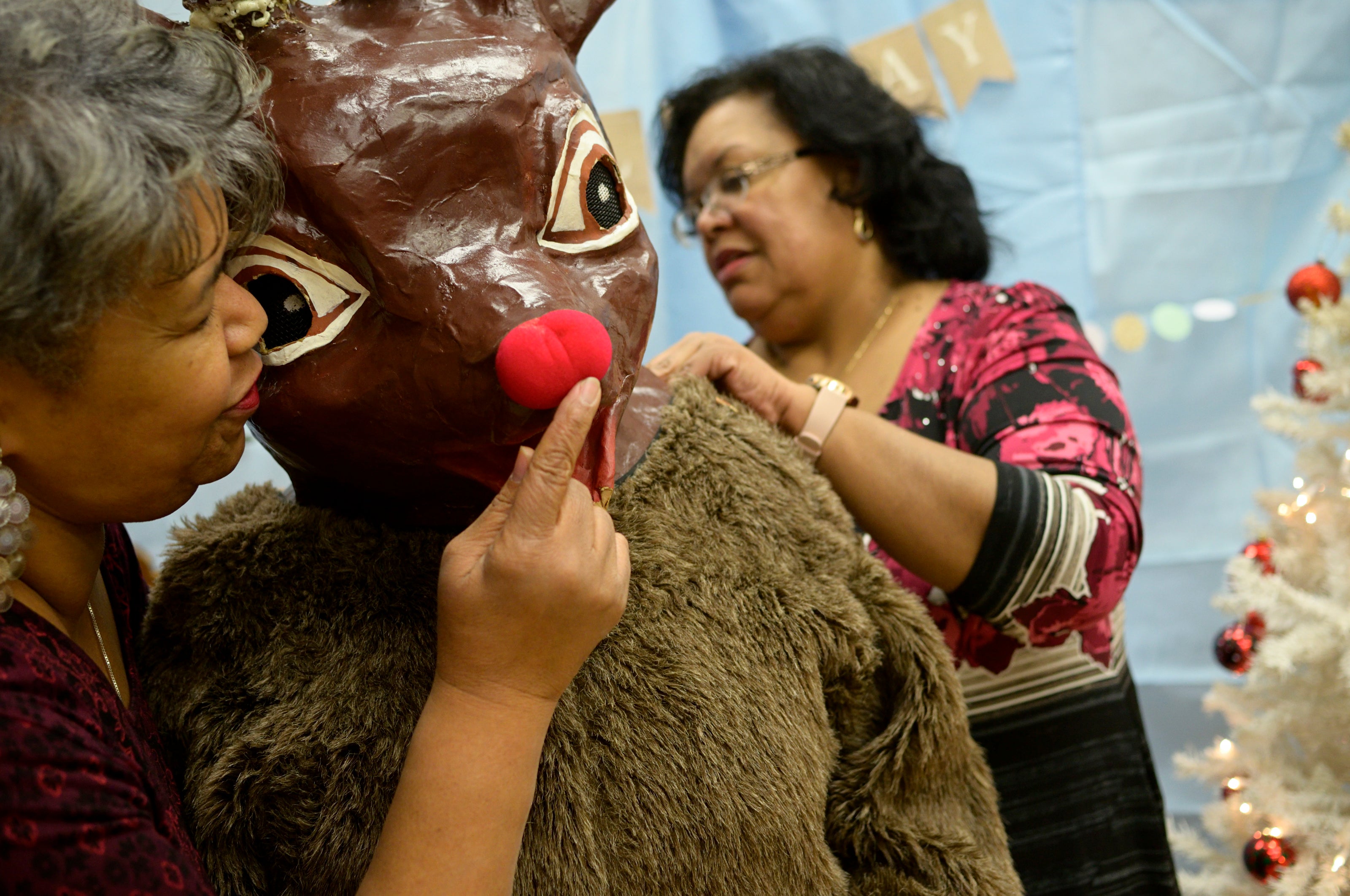 Staff members from Councilwoman Parker's office help prep Rudolph for the Annual Winter Festival in Olney. Bas Slabbers/WHYY.