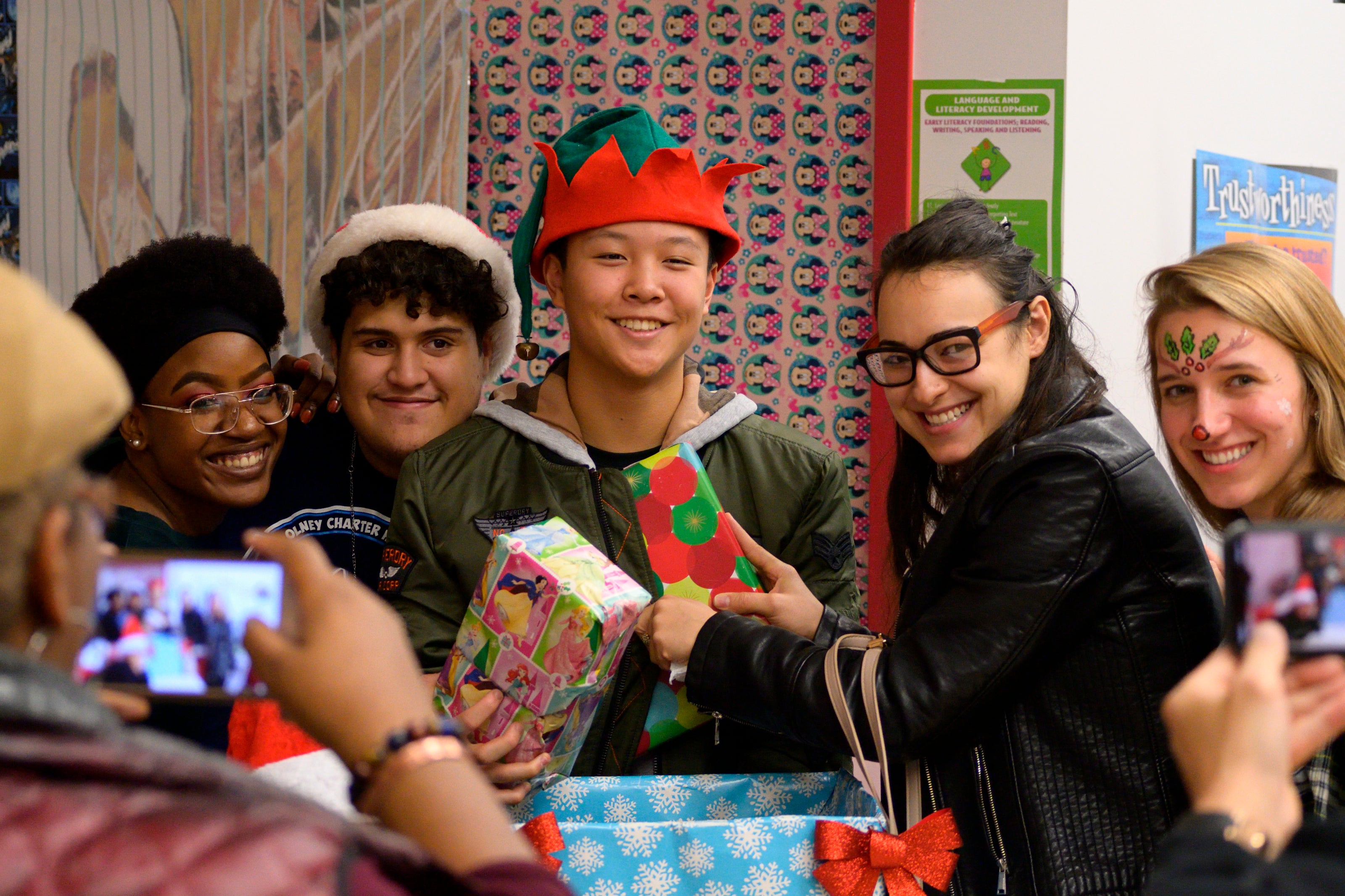 Volunteers take a pause from passing out gifts during the Annual Winter Festival in Olney. Bas Slabbers/WHYY.