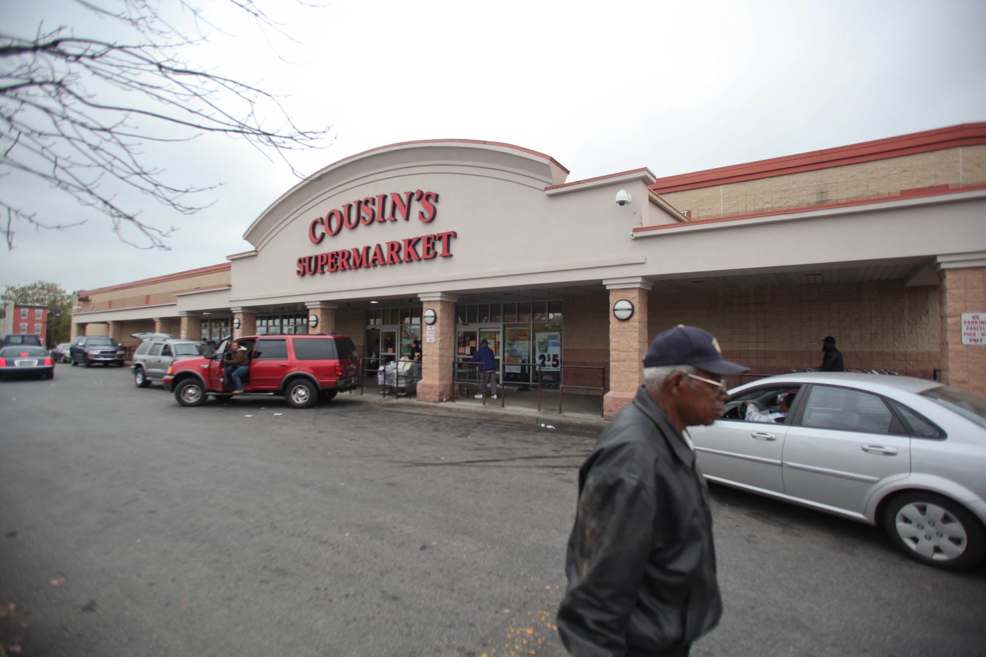  A customer walks away from Cousin's Supermarket, located at 5th and Berks streets. 
