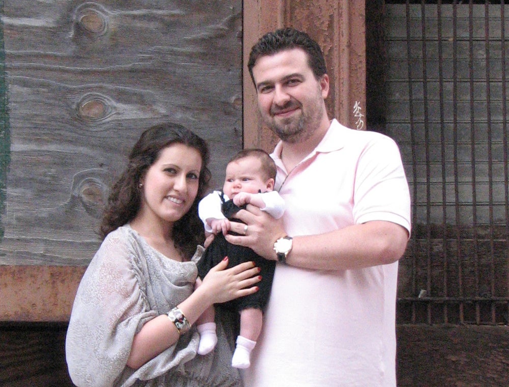 Julia and Igor Frayman, with Ava, in front of the Bouvier Building.