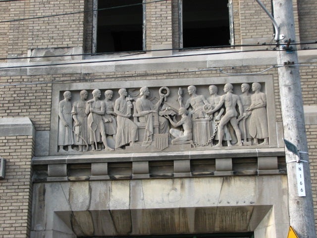 A bas-relief sculpture above the north entrance celebrates the school's vocational mission.