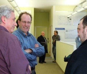 Bob Kaufman, Ken Weinstein, and Josh Romalis talk at an open house earlier this week. (Photo by Erica Hawthorne)