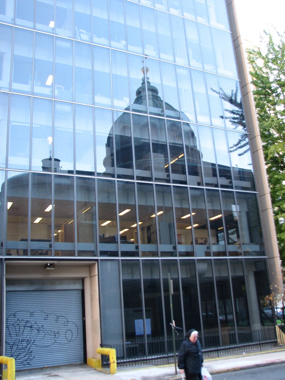 The glass wall on the north side reflects the Cathedral Basilica.