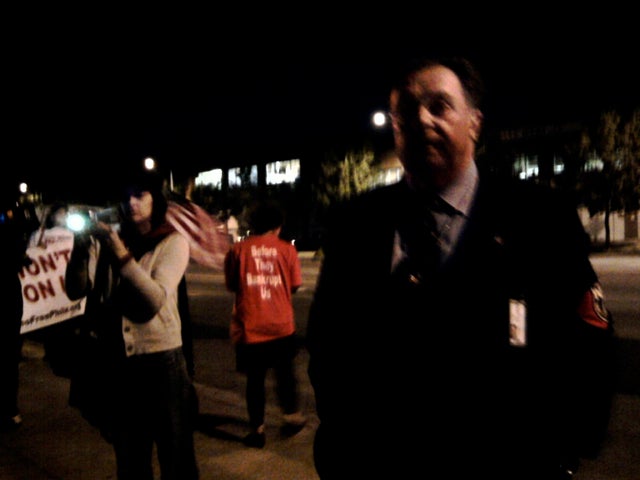 Police captain William Fisher, commanding officer of the civil affairs unit, watches protesters after issuing first warning