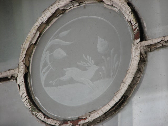 At the center of some windows are etched glass animals.